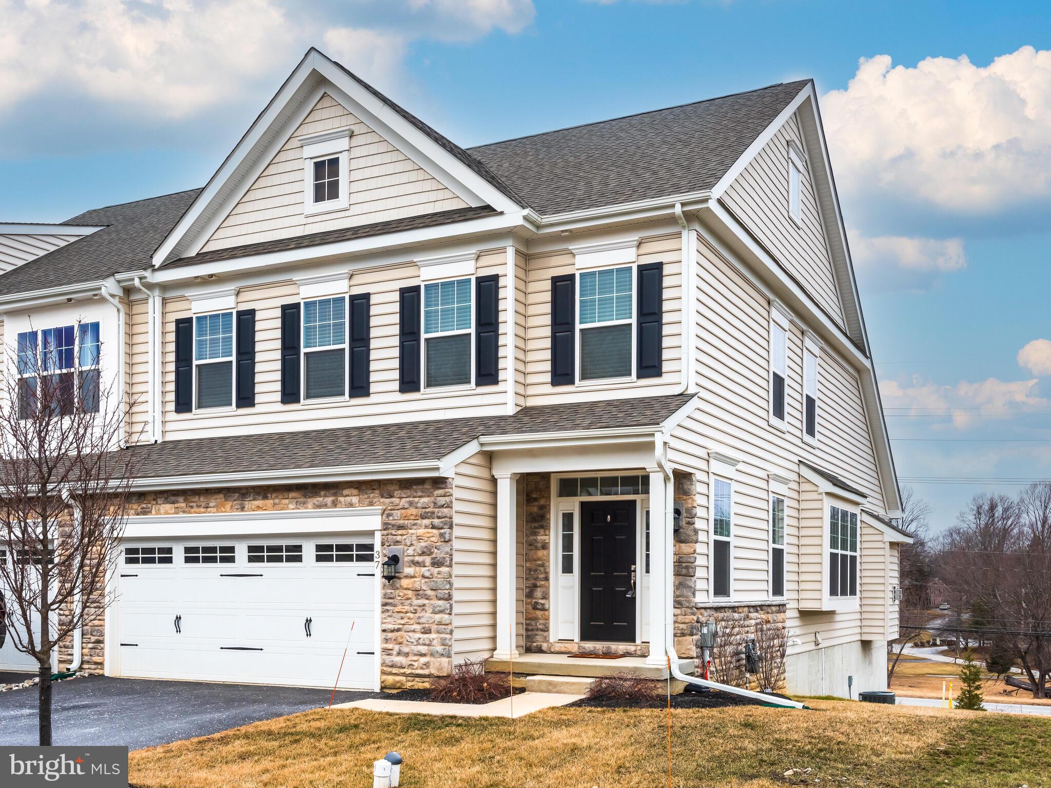 Shows like a model home! Presenting a beautifully finished and move-in ready Ascot Grand home in the newer Willistown Point community which features a MAIN FLOOR PRIMARY BEDROOM SUITE in an END unit. Willistown Pointe is an exclusive enclave of only 39 luxury carriage homes in Willistown Township, Chester County by Rouse Chamberlin Homes.  Welcome to 37 Midsummer Drive in the charming township of Willistown, PA in Great Valley School District.   This home is ready for a quick move in and offers low maintenance living. This spacious property provides ample room for comfortable living. The first-floor primary bedroom suite offers convenience and privacy, while the first-floor laundry room adds an extra touch of convenience to your daily routine. The dining area boasts a beautiful box-bay window that fills the space with natural light, creating a warm and inviting atmosphere. The kitchen is a chef's dream featuring many designer options including an oversized island with storage on both sides, granite countertops (which have been sealed), gas cooking, upgraded cabinets with pull-outs and soft close drawers, tile backsplash and under cabinet lighting. The Great Room is adorned with a gas fireplace and vaulted ceiling, adding an element of grandeur to the space along with door to the elevated deck.   You'll also be delighted by the incredible second-floor loft/Flex area, complete with an oversized walk-in closet,  two additional large bedrooms and hall bathroom with tub. This versatile space can be transformed into a home office, workout area, or whatever suits your needs. The property includes desirable features such as 9' foundation walls in the daylight walk out basement along with rough-in for full bathroom for future finishing.  With a two-car garage and two additional parking spaces in the driveway, you'll never need to worry about finding a spot for your vehicle. Hardwood floors throughout most of home for a seamless transition along with 2 zoned HVAC system for efficiency!The community features walking trails, which connect to Worington Commons and Willistown Woods, so you can walk for miles without even getting into your car. Conveniently positioned in Willistown Township, this carriage home offers easy access to nearby amenities such as numerous golf courses, West Chester YMCA, Ridley Creek State Park, Okehocking Preserve, East Goshen Township Park, Chester Valley trail for biking. Paoli Amtrak & Septa Train Station (7 miles). Located near the most popular boroughs and cities in Southeastern Pennsylvania such as  West Chester (5 miles), Newtown Square (6 miles), Malvern (6 miles), Media (10 miles) King of Prussia (17 miles). Don't miss out on this incredible opportunity; schedule a showing today!