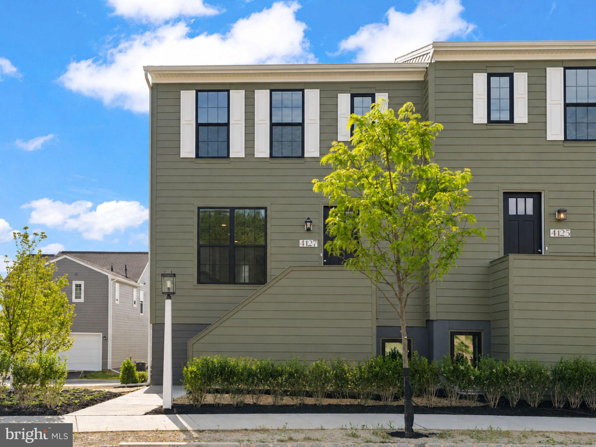 Move right into this sun-filled end-unit townhome in the newest phase of Arcona, perfectly positioned on a premium homesite just a short walk from the neighborhood pool. Offering enhanced privacy, extra windows, and scenic neighborhood views, this home combines stylish design with everyday convenience. The striking exterior showcases Mountain Sage Hardie® Plank siding, Arctic White trim, and sophisticated black-trimmed windows that create exceptional curb appeal. A private rear balcony extends your living space outdoors, providing the perfect spot to enjoy morning coffee or unwind at the end of the day. Inside, the open-concept main level is designed for modern living and entertaining. Luxury vinyl plank flooring flows throughout the space, while oversized windows fill the home with natural light. The designer kitchen features granite countertops, white cabinetry accented by a slate-stained island, a full tile backsplash, and stainless steel gas appliances. The spacious great room and dining area connect seamlessly, creating an inviting atmosphere for gatherings large and small. Upstairs, the primary suite offers a walk-in closet and a spa-inspired bath. Two additional bedrooms and a full bath provide flexible space for family, guests, or a home office. The finished lower level adds valuable living space with a versatile game room, expanded gallery, laundry area, and convenient boot room. Ready Summer 2026. Nestled in a picturesque valley on the West Shore of Harrisburg, Arcona offers a wealth of lush parks, artisanal dining options, exclusive shopping venues, and local coffee shops just moments from your doorstep.