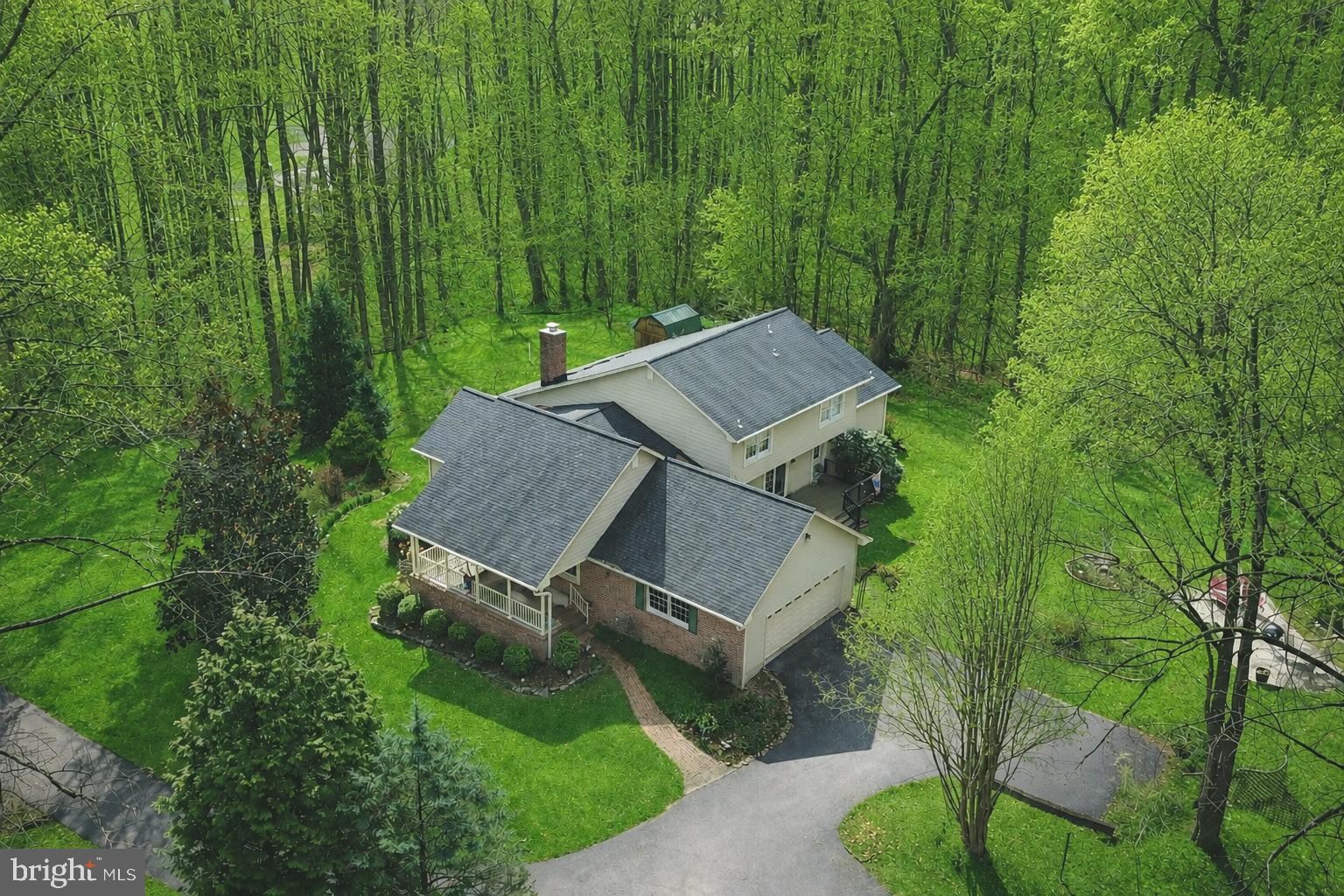 Custom built home in a private and unique setting surrounded by mature trees, this charming brick-front home offers space, character, and peaceful surroundings while still being conveniently located. Two car side load garage with ample parking for guests. The main level offers a well-designed layout including a welcoming foyer, a spacious living room, dining rm ,two story family room with a fireplace, opens to a sunroom —perfect for relaxing evenings and entertaining. The kitchen is situated for those who like to cook and enjoy nature at the same time.

The main-level primary suite, complete with a dressing room, walk-in closet, and private bath, offering convenience and privacy.

Upstairs, you will find two additional bedrooms and a full bath, providing comfortable accommodations for family or guests and a storage room. 

Discover the ultimate footprint for entertainment and relaxation with a fully finished walkout basement. The recreation room creates an inviting atmosphere for movie nights or a secondary lounge. Adjacent to rec room, the dedicated game room comes ready for play, featuring a pool table set beneath a classic billiard-style pendant, casting the perfect glow for your next tournament. A generous fourth bedroom outfitted with stylish wood-look vinyl plank flooring for a modern, durable finish. This private retreat includes an attached den, offering the perfect setup for a quiet library, guest quarters, or a secluded home office. A full bath ensures comfort and convenience for guests and residents alike. Seamless indoor-outdoor living is achieved through the walkout access, leading you to a covered paver patio overlooking the private wooded lot.

Enjoy the privacy of 6+ acres which includes an additional parcel just shy of 1 acre conveyed with the main parcel.

PROFESSIONAL PHOTOS COMING SOON!

Roof: +/- 5 years; 3 zones heat pumps: zone 1=primary bedroom (2019), zone 2=main level (2019), zone 3=upper level (2008); ductless systems in basement (x2): 2026. Water heater: 2009. Verizon broadband/fiber optic is available.