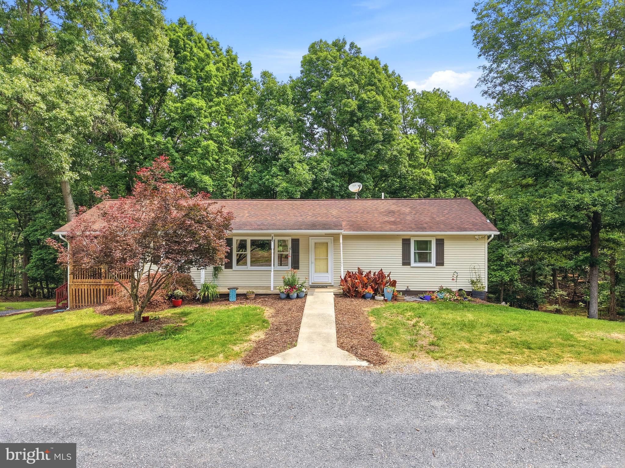 Tucked away on 9.3 acres near New Market, VA , this 3-bedroom, 2-full-bath home offers the privacy, space, and peaceful setting buyers are looking for. Inside, you’ll find LVP flooring throughout the home, spacious living room with a cozy propane fireplace, and an open dining area that creates a comfortable flow for everyday living and entertaining.

The kitchen features granite countertops, hickory cabinets, and stainless-steel appliances, bringing warmth and function together in the heart of the home. Just off the living room, a screened porch overlooks the side yard, garden space, and chicken coop, making it the perfect spot to enjoy quiet mornings, evening relaxation, or the beauty of the surrounding wooded acreage.

Down the hall are two bedrooms and a full bathroom. The partially finished walkout basement adds even more flexible living space with a versatile den, an additional bedroom, and a full bathroom with a walk-in shower. The unfinished portion of the basement is ideal for storage, hobbies, or a workshop.

Outside, the wraparound gravel driveway provides ample parking and easy access around the property. With 9.3 mostly wooded acres, usable outdoor space, and a private setting, this New Market property offers a wonderful opportunity to enjoy country living with room to spread out.