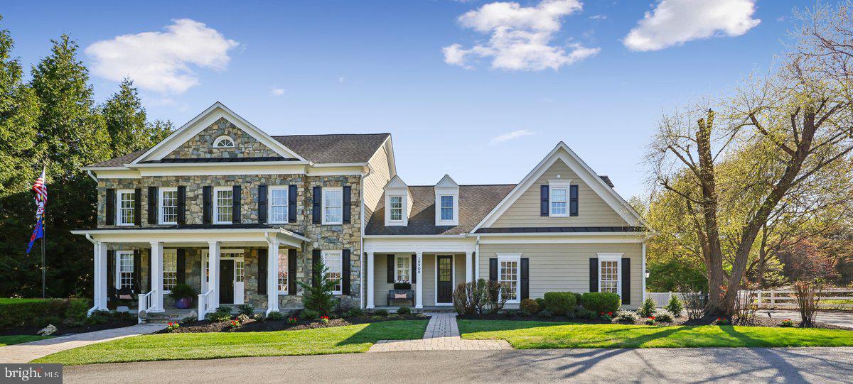 Rare opportunity to own a spectacular custom showpiece residence with a Private Attached In-Law Suite on main level,  set on a picturesque 2-acre lot adjacent to Travilah Meadows. This exceptional six-bedroom, five-and-a-half-bath stone Colonial offers over 6,500 square feet of beautifully finished living space across three levels, including approximately 4,800 square feet above grade.

Designed for both elegant living and everyday comfort, the home is filled with natural light and showcases 9-foot ceilings on all levels, hardwood flooring throughout the main and upper levels, designer carpeting on the lower level, ceramic tile baths, extensive moldings, recessed lighting, and custom built-ins.

A grand foyer welcomes you with sidelights and a wide hardwood staircase. The formal living and dining rooms feature refined architectural details, including a gas fireplace in the living room. A private main-level office with balcony access sits adjacent to a powder room.

The family room is a true focal point, featuring a coffered ceiling, wall-to-wall custom cherry built-ins, and a dramatic floor-to-ceiling stone wood-burning fireplace with propane starter with double glass doors to the lanai and deck.

The gourmet kitchen is beautifully appointed with custom cabinetry, quartz countertops and backsplash, farmhouse sink, and premium JennAir appliances—including two dishwashers, two refrigerator drawers, microwave, and a 48” six-burner range with griddle and double ovens—complemented by a Sub-Zero side-by-side refrigerator. The adjoining breakfast area opens via French doors to a covered lanai, Trex and vinyl deck, and expansive backyard.

A private in-law suite, conveniently located off the kitchen, includes a full kitchen, living area, bedroom, bath, and laundry—ideal for extended family or guests.

Upstairs, the luxurious primary suite features a tray ceiling, gas fireplace, and dual custom walk-in closets. The spa-inspired bath includes dual quartz vanities, a walk-in tiled shower with bench, Kohler soaking tub, and separate water closet. Three additional bedrooms, two with en-suite bathrooms and one with a custom full bath, along with a den/office and bonus loft area, complete the upper level.

The fully finished walk-out lower level is designed for recreation and relaxation, offering a large recreation room with gas fireplace, game room with card nook, theater/simulator golf room, exercise room, bedroom with patio access, full bath, and ample storage.

Outdoor living is equally impressive, with a covered lanai, expansive decking, sport court, and multiple balconies overlooking the serene grounds.

Additional features include a whole-house generator and lawn sprinkler system. 

Proposed Possible 2 Car Detached Garage.