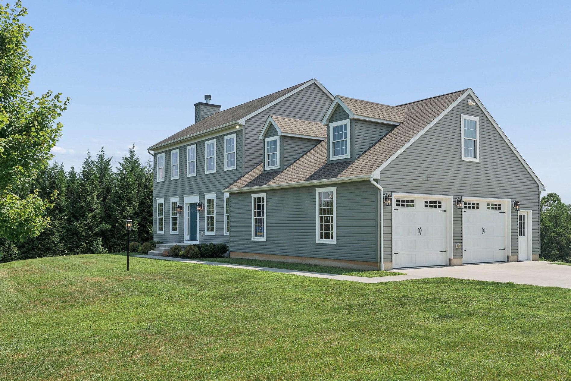 A rare offering in the highly sought-after Hereford School Zone! This 2013-built colonial combines the advantages of newer construction with a neutral, move-in ready interior and a highly livable floorplan. Enjoy scenic countryside views on your approach and timeless curb appeal upon arrival. Inside, abundant natural light, on-trend finishes and seamless hardwood flooring create a warm, inviting feel. The foyer opens to a spacious living room with cozy fireplace and flows into the dining area and well-appointed kitchen featuring 42-inch cabinetry, a center island with seating, stainless steel appliances, and a double pantry. Step outside to the newly constructed rear deck overlooking a private backyard with mature screening—perfect for summer gatherings, outdoor dining, and relaxing evenings around the firepit. Upstairs, the primary suite offers a walk-in closet and private bath, while two additional bedrooms with double closets share a stylish hall bath. The finished two-car garage is a standout feature, complete with a durable epoxy-coated floor. The walk-up unfinished attic above provides excellent storage or the opportunity for future expansion. The walk-out lower level is clean, bright, and ready for your finishing touches. Fresh paint, new carpet, Andersen replacement windows and a brand-new HVAC complete this move-in ready home!