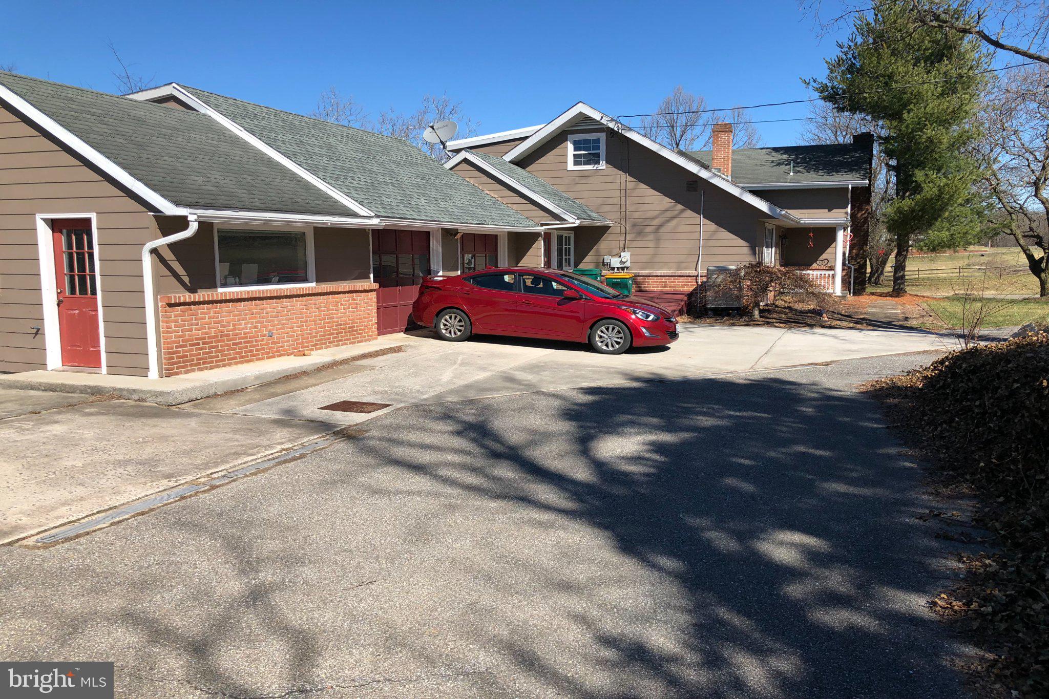Perfect for Contractors, Landscapers, Electricians, Plumbers, Consultants, Insurance Professionals, Travel Advisors, Salon Owners, Mechanics, Car Enthusiasts, Home-Based Businesses, and Entrepreneurs Seeking a Live/Work Property!

EXCEPTIONAL LIVE/WORK OPPORTUNITY ON OVER 2 ACRES — HOME, BUSINESS & LIFESTYLE ALL IN ONE!

Seller now offering a $10,000 closing cost credit with an acceptable offer.

What if your home could grow your business too?

Most properties make you choose between having a place to live and a place to work. At 21680 Leitersburg Pike, you can have both.

Situated on over 2 acres of mostly level, usable land, this unique property offers a rare combination of residential comfort, business flexibility, abundant parking, and exceptional workspace. Whether you're an entrepreneur, contractor, landscaper, electrician, plumber, consultant, insurance agent, accountant, travel advisor, salon professional, remote worker, or small business owner, this property was designed to adapt to your vision.

The home features 5 bedrooms, 3.5 baths, and FIVE levels of finished living space, providing flexibility for multi-generational living, private guest accommodations, home offices, hobby areas, or future expansion needs.

Inside you'll find:

• Spacious living and dining areas ideal for everyday living and entertaining
• Bright, functional kitchen with room to gather
• Flexible floorplan offering multiple living arrangements
• Potential in-law or guest suite options
• Separate business entrance ideal for client meetings, consultations, appointments, or a dedicated office environment
• Multiple spaces that can easily serve as offices, studios, workspaces, or meeting rooms

One of the property's standout features is the incredible 4+ car garage and workshop space. Whether you need room for vehicles, equipment, inventory, tools, hobbies, projects, storage, or a growing business, opportunities like this are becoming increasingly difficult to find.

Outside, the possibilities continue. The expansive grounds offer abundant parking for employees, customers, trailers, equipment, recreational vehicles, or business vehicles. The level acreage provides room to expand your vision while still enjoying plenty of outdoor space for recreation, gardening, animals, entertaining, or simply enjoying country living.

Imagine owning the building your business operates from.

Imagine eliminating the daily commute.

Imagine building equity while building your company.

Properties offering this level of flexibility, workspace, acreage, parking, and business potential rarely become available.

The seller has completed numerous improvements, making this property move-in ready for its next chapter.

Schedule your private tour today and discover the possibilities that 21680 Leitersburg Pike has to offer..
