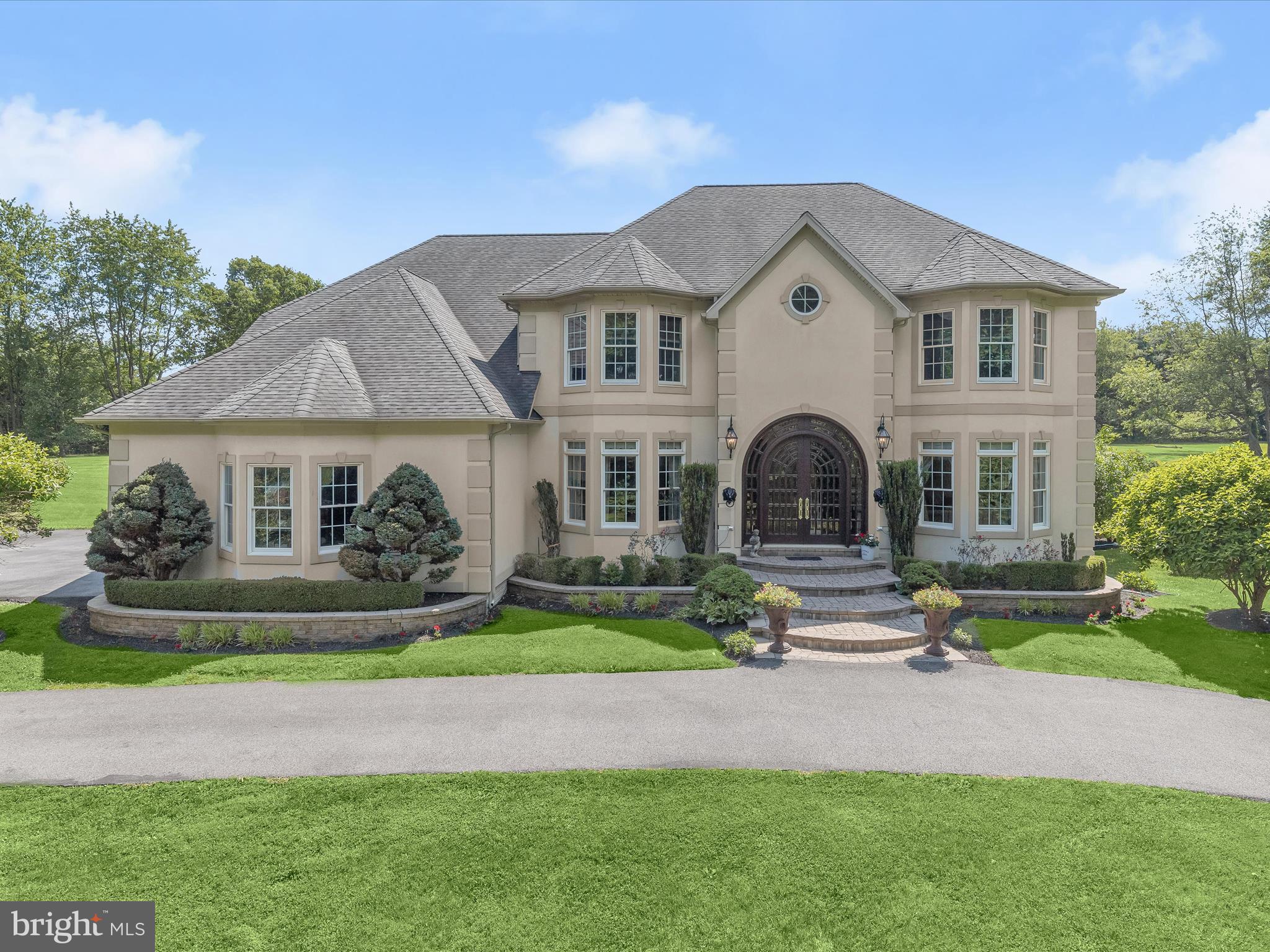 Nestled on 4.42 serene private acres in the coveted Kings Gift community, this exquisite estate epitomizes luxury and elegance. The property is adorned with spectacularly manicured grounds, lavish gardens, an incredible pool, and a phenomenal outdoor entertainment paradise, perfect for hosting gatherings or enjoying tranquil moments. A custom Palladian double door welcomes you into the grand foyer, where elegant lighting, a soaring ceiling, and curved stairs set a tone of refined opulence. The adjacent formal living and dining rooms, graced with intricate molding and light-filled windows, provide an ideal setting for entertaining guests. At the heart of the home lies a kitchen that is a true chef’s delight, featuring a professional-grade six-burner gas stove, double oven, prep sink, Sub-Zero refrigerator, two disposals, an ice machine, island, breakfast bar, display cabinetry, and a pantry. Savor your morning paper by one of the three fireplaces or step outside to the veranda with your tea. The family room, with its second fireplace, two ceiling fans, and double doors leading to the veranda, offers a cozy yet sophisticated retreat. A convenient main-level ensuite bedroom doubles as an optional office, while a full bath for bathing animals and a powder room add to the main level's functionality. Ascend one of two staircases to discover the sprawling primary suite, adorned with a double-sided fireplace, a sitting room, two sizable walk-in closets, and access to a private balcony. Three additional spacious bedrooms, each with ample closet space, an ensuite bath, a full bath, and a laundry room complete the upper level. The lower level has been framed and sheet rocked, ready to accommodate multiple additional rooms and a full bath, providing endless possibilities for customization. This home, with its resort-style amenities and remarkable design, offers an unparalleled living experience in the heart of Kings Gift.