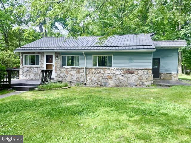 Lake cottage (5 Bedrooms) on large level lot with path to your own private class A dock & 25' of Lakefront, directly across the street.  This comfy (one level living) cottage sits on 1.8 level acres with 2 storage garages and mature landscaping. 5BRs, open living, dinning & kitchen area, with lots of sunlight.  1 full & 1-1/2 bath, with 5 Bedrooms! Laundry room located off back of the home. Cute and cozy, well maintained and move in ready, with sleeping for 12 heads on beds (several bunks)!  2 garages with plenty of storge for your lake & yard toys.  The lot has mature landscaping & circular paved driveway, for easy in and out during all seasons.  Private path to your lakefront dock is an easy walk across the street.  Nice level lake front, no steps to go onto your dock! Buydown Included on Lakefront.  Great opportunity to get onto the lake at an affordable price, call agent to set up an appointment or with any questions.