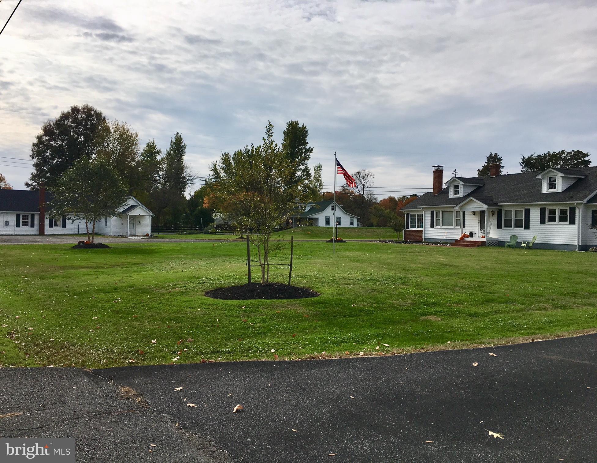 Unique property w/main house + out building  used as gym/rec room w/1/2 BA. Well maintained & improved. Beautiful wood floors, FP,wood stove, huge laundry/utility, bright sunroom. New septic& HVAC, newer roof on cottage & main house, crawl has been conditioned, generator-ready.  Deep front yard + fully fenced lge back yard.  Det. garage, home warranty. Main house 2BR/1BA  1650sf,
