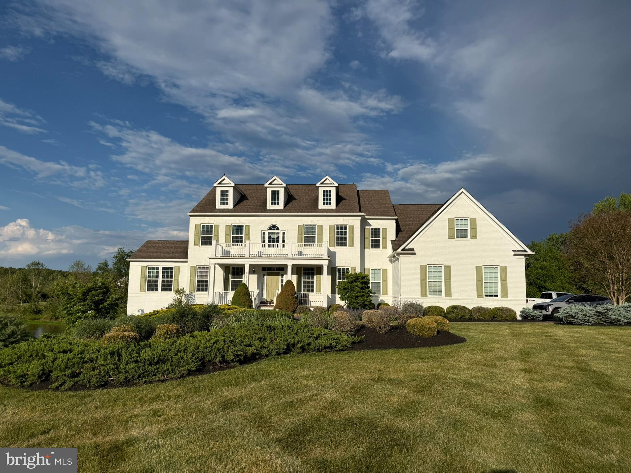 Experience the pinnacle of refined living in this magnificent 7,420+ square foot contemporary estate, standing as a landmark of architectural distinction within the prestigious Huntleigh at Creighton Farms. Meticulously master-crafted by Stanley Martin, this former model home is an embodiment of stately elegance, defined by its commanding presence, soaring ceilings, and a seamless blend of sophisticated design and exceptional craftsmanship. The residence unfolds with grace, offering distinguished living spaces including a gourmet chef’s kitchen, a stately library for quiet contemplation, and an expansive lower-level retreat, all finished with the finest materials. With 5 large bedrooms and 5.5 luxurious baths, and a super oversized principal bedroom closet to store all of your shoes/clothes/garmets. The home provides an atmosphere of unparalleled comfort and refined privacy.

The exterior is a testament to natural beauty, seamlessly integrated with professionally curated landscaping and mature plantings that provide both color and structure throughout the seasons. The grounds extend gracefully to the water’s edge, where the property’s allure is underscored by a serene, lighted pond that serves as a private oasis and ads to the view. This idyllic waterfront setting offers a unique luxury—exclusive access to catch-and-release fishing right from your own backyard. Residents may transition from the home’s newly installed Trek deck to an expansive, hardscape patio with built in fire pit that serves as the ultimate gathering spot for evenings under the stars.

Beyond its aesthetic majesty, this estate is engineered for the discerning owner, featuring a suite of high-end, proactive enhancements designed for longevity and ease. Notable upgrades include a whole-house electrical backup generator, a sophisticated total-home water filtration system with integrated hard water treatment and UV sterilization, and a state-of-the-art security system complete with comprehensive interior and exterior camera surveillance. Practical luxury meets modern innovation with the addition of a dedicated Tesla EV charger. Situated in one of Loudoun County’s most exclusive enclaves, this property offers more than a residence; it provides a legacy of prestige, tranquility, and turn-key perfection for the most demanding buyer.