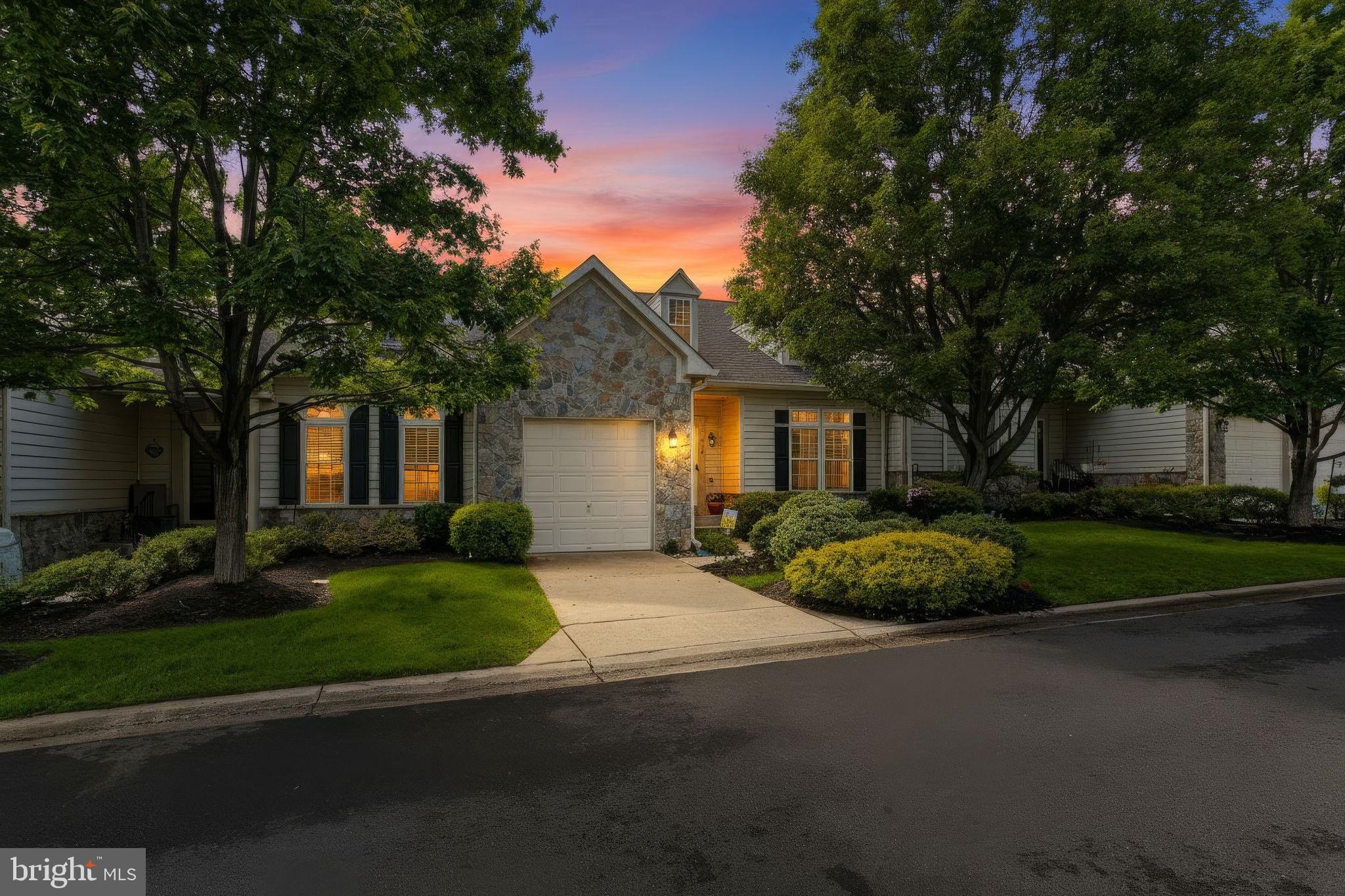 Welcome to this spacious and beautifully updated villa located in a charming 55+ community surrounded by peaceful natural scenery, mature trees, and lush landscaping. Backing to Forest Preservation land, this home offers the perfect blend of privacy, comfort, and low-maintenance living in a serene setting designed for relaxation and convenience. Inside, you’ll find a thoughtfully designed floor plan featuring a main-level primary suite with a walk-in shower, creating the ease of one-level living. The gourmet kitchen is equipped with granite countertops, a pantry, and updated appliances including a refrigerator, dishwasher, and double ovens. Just off the kitchen, the bright rear sunroom is the perfect place to enjoy your morning coffee while taking in views of the lawn and surrounding trees. Step outside onto the private deck, complete with a brand new awning that provides the perfect balance of shade and sunshine—ideal for gardening enthusiasts looking to grow herbs or tomatoes. The upper level offers an inviting retreat for guests with two generously sized bedrooms, a full bath, loft area, and a large storage closet. The fully finished lower level expands the living space even further with a spacious recreation area, an additional private room, full bathroom, and abundant storage options. Recent updates provide peace of mind and include a new HVAC system (2024), water heater (2025), rear windows and sliding door, new carpet, and a new deck awning. With ample guest parking, tranquil surroundings, and spacious living across multiple levels, this villa offers exceptional comfort in one of the area’s most desirable active adult communities.