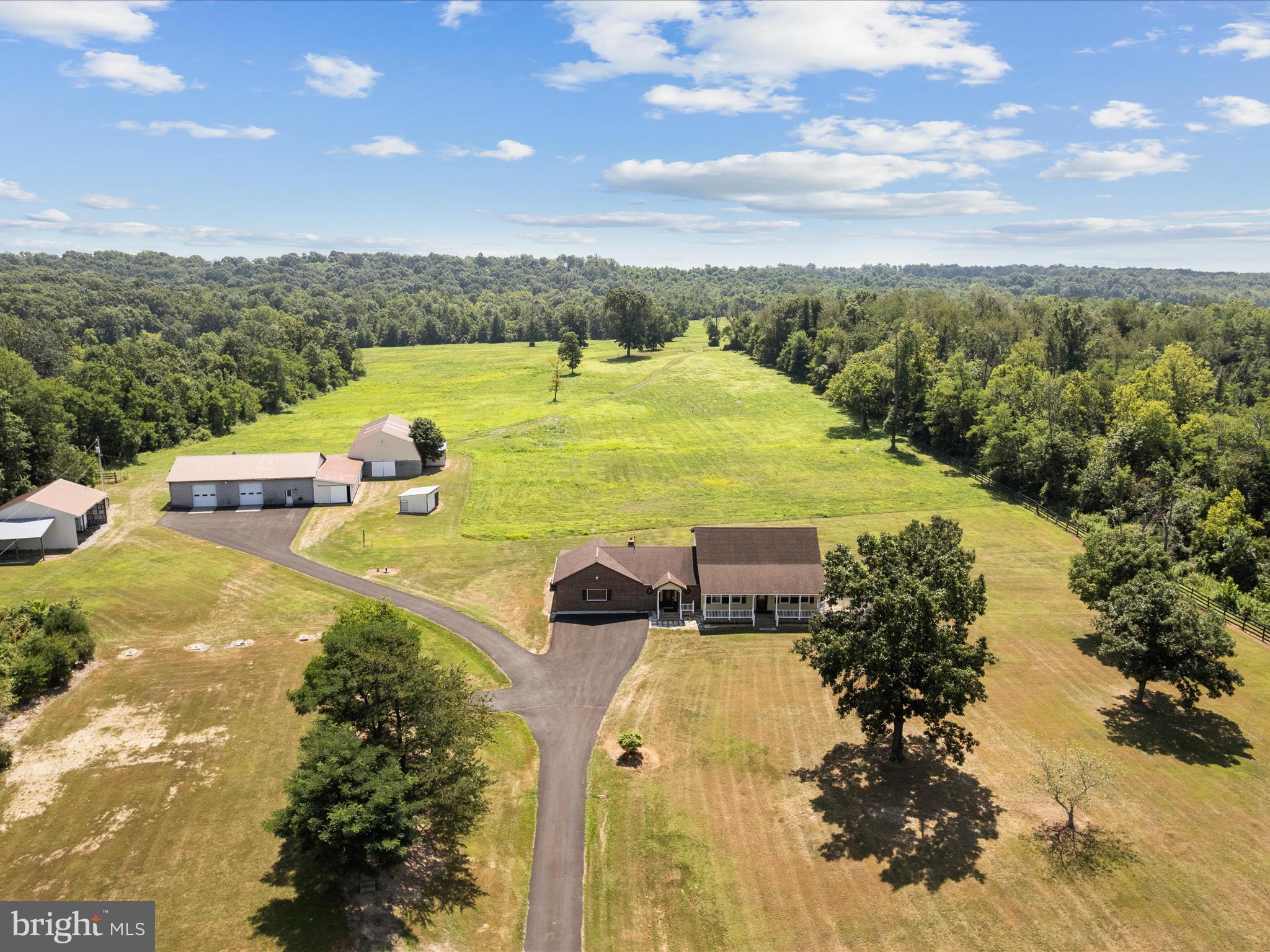 Welcome to 3025 Dominion Road, a great place for horse lovers and land seekers. This property covers 76.96 acres of peaceful countryside and combines comfortable living with equestrian facilities. The two-story home, built in the 1980s, has about 3,000 square feet of space, including four large bedrooms, two bonus rooms, and two full bathrooms. The front porch is perfect for enjoying wide-open views. 
The home features a hand-carved wood door from Honduras and custom stained glass cabinets. The back sunroom fills with natural light year-round, allowing you to appreciate the calming countryside views. 
The property includes 14 horse stalls with a loft above, a run-in shed, a tack room, and a wash bay. The 40x60 garage offers plenty of room for vehicles, equipment, or a workshop. A peaceful pond adds to the property’s natural beauty. 
Whether you want a private getaway, a working farm, or a top-notch horse property, this unique offering provides ample space, beautiful scenery, and flexibility for your personal touch. 
Recent updates include new windows (2025), a new roof (2022), new carpet (2025), and a new hot water heater and pressure tank (2025).