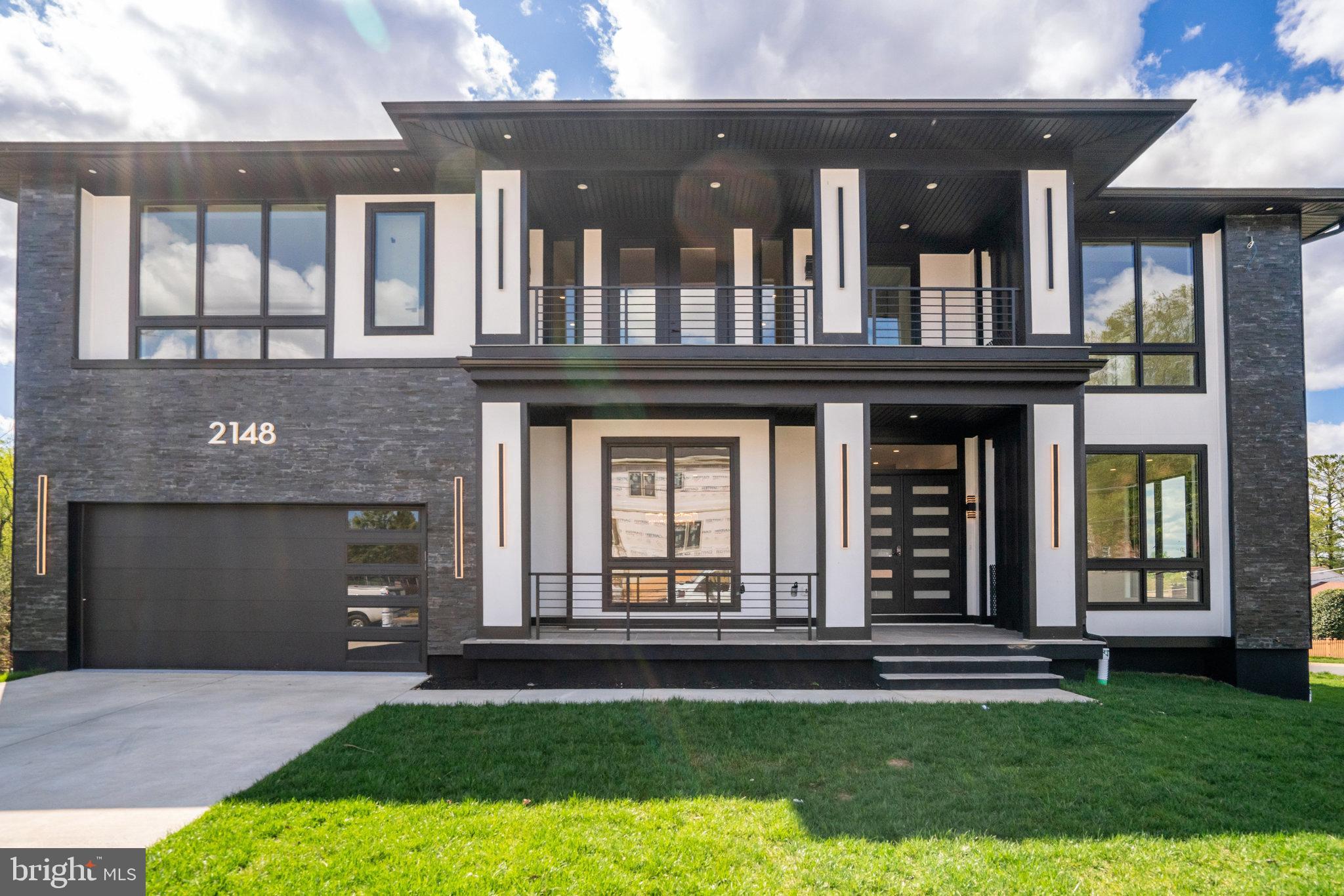 Nestled in the heart of Falls Church. With over 7,289 square feet of living space, this residence is a testament to meticulous design and thoughtful attention to detail. 
The architectural plan reveals a harmonious blend of comfort and privacy, with seven generously proportioned bedrooms, each with its own en-suite bathroom and custom closet. The main level is an ode to modern living with ceiling height of 11ft and an open floor plan that is both contemporary and welcoming. The white oak floors provide a canvas for customization, allowing you to select the finish that best suits your aesthetic. 
Entertaining is effortless with a formal dining room that transitions smoothly into a state-of-the-art gourmet kitchen through a well-equipped butler’s pantry. The kitchen is a chef's dream, featuring top-of-the-line Thermador appliances and a kitchen island with bar-style seating. This culinary haven opens to a cozy breakfast area, perfect for informal family gatherings. 
The family room, anchored by a warm gas fireplace and offering direct patio access, is the home's heart, designed for relaxation and social gatherings. A guest bedroom on the main level ensures comfort and convenience for visitors, complete with an en-suite bathroom and walk-in closet. 
The upper level , the primary suite stands out as a sanctuary of luxury, with dual walk-in closets and an opulent en-suite bathroom complete with a shower and soaking tub. Each of thebedrooms is a private retreat, featuring walk-in closets and individual en-suite bathrooms. The family loft adds another layer of versatility to the home, providing a space for relaxation or play, along with convenient balcony access. 
The full basement extends the living space further, offering a recreation room with a wet bar, two bedrooms with en-suite bathrooms, and a media room dedicated to entertainment. A separate gym room caters to the wellness enthusiast, while ample storage space ensures practicality. The mudroom leads to a spacious 2-car garage, completing the layout of this exceptional home. 
This residence is not just a house; it is a promise of a lifestyle that embodies sophistication, luxury, and unparalleled comfort. It awaits the discerning individual who values quality, elegance, and the opportunity to create a home that is truly their own.