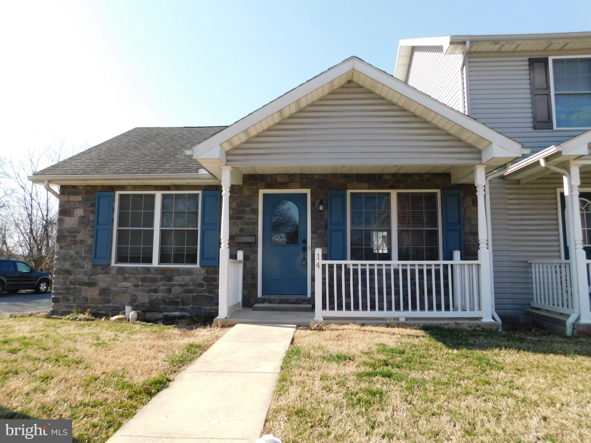 MOVE IN READY!  ALL one level.  Newly renovated kitchen and bathroom, freshly painted. Centrally located.  Appliances convey.  Vaulted ceilings in the living room with floor to ceiling fireplace/mantel . Vaulted ceilings in each bedroom. Newer flooring throughout. Newer HVAC.  Covered front porch, rear deck and small yard.  2 designated parking spaces adjacent to the unit.