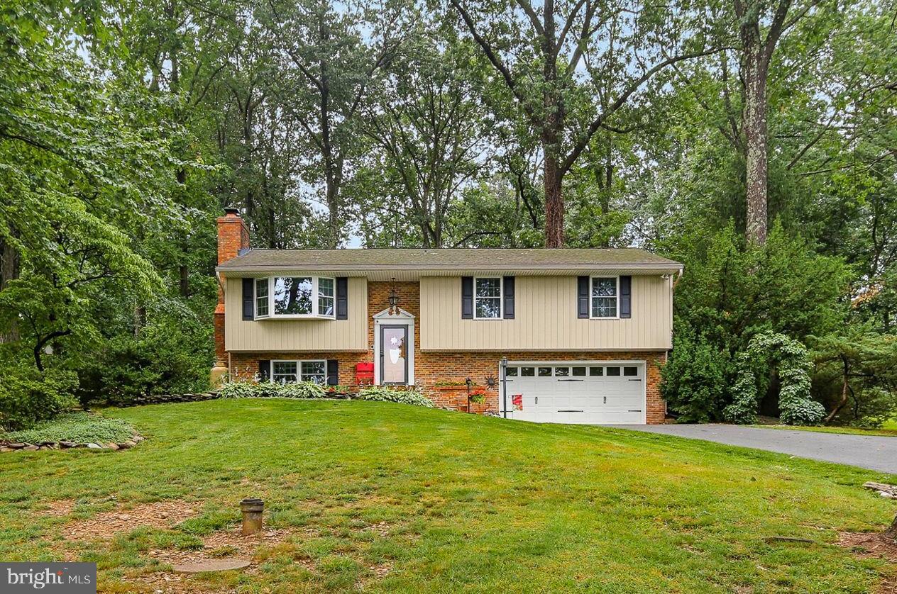 Welcome to 605 East Court, Westminster, MD – a well-maintained split foyer home offering 3 bedrooms, 2 full baths, and 1 half bath with comfortable living spaces inside and out. Nestled on a private, wooded lot, this home combines a peaceful setting with functional living and an inviting outdoor retreat.

The main level features a bright and spacious living room highlighted by large windows that fill the space with natural light and a cozy fireplace that creates a warm and welcoming atmosphere. The adjoining dining area provides an ideal space for everyday meals or entertaining guests, while the kitchen offers ample cabinetry and workspace for all your culinary needs. The main level also includes the primary suite with a private full bath, two additional generously sized bedrooms, and a shared full hall bath.

The finished lower level expands the living space with a comfortable family room centered around a second fireplace, making it the perfect spot for movie nights, game days, or relaxing evenings at home. A versatile den offers possibilities as a home office, exercise room, or guest space. A convenient half bath, laundry area, and access to the attached one-car garage complete the lower level.

Step outside to enjoy the expansive deck overlooking the private backyard, surrounded by mature trees and established landscaping. Whether hosting summer gatherings, enjoying morning coffee, or simply taking in the peaceful surroundings, this outdoor space is sure to impress. A storage shed provides additional room for lawn equipment and outdoor essentials.

Conveniently located near downtown Westminster, residents can enjoy shopping and dining at TownMall of Westminster and Westminster Shopping Center, along with abundant outdoor recreation at King Park, Landon C Burns Park, and Deer Park. This home also offers convenient access to major commuter routes while maintaining a tranquil residential setting.

Don't miss this opportunity to make this charming Westminster home your own!