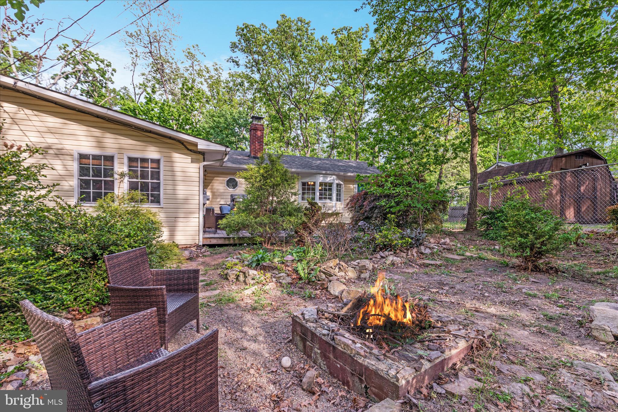 Welcome to your own private retreat in Shawneeland, where wooded surroundings, community amenities, and comfortable one-level living come together just minutes from Winchester.

Tucked among mature trees on a beautifully landscaped lot, this 3-bedroom, 2-bath ranch offers the perfect blend of privacy, character, and move-in-ready comfort. The fully fenced front yard creates a peaceful outdoor escape, complete with a fire pit area ideal for relaxing evenings or entertaining guests.

Inside, the home offers warm, inviting living spaces filled with personality, including a spacious living room anchored by a wood-burning fireplace and a charming window seat perfect for reading, dining, or simply enjoying the natural views.

The updated kitchen offers both style and functionality with abundant natural light, open shelving, a garden window, and generous prep and storage space. A flexible bonus room provides options for a home office, formal dining room, hobby space, or additional living area, with easy access to the outdoor entertaining space.

The spacious primary suite features a walk-in closet and private bath, while two additional bedrooms and a second full bath offer room for guests, family, or work-from-home needs.

Outdoor living continues with patio and entertaining space, wooded privacy, and useful storage with an on-site shed.

As part of the Shawneeland community, enjoy access to amenities including a lake, beach, playgrounds, picnic areas, and recreational spaces that make every season enjoyable.

Conveniently located just minutes from shopping, dining, and downtown Winchester, this home offers a rare opportunity to enjoy peaceful mountain living without sacrificing convenience.