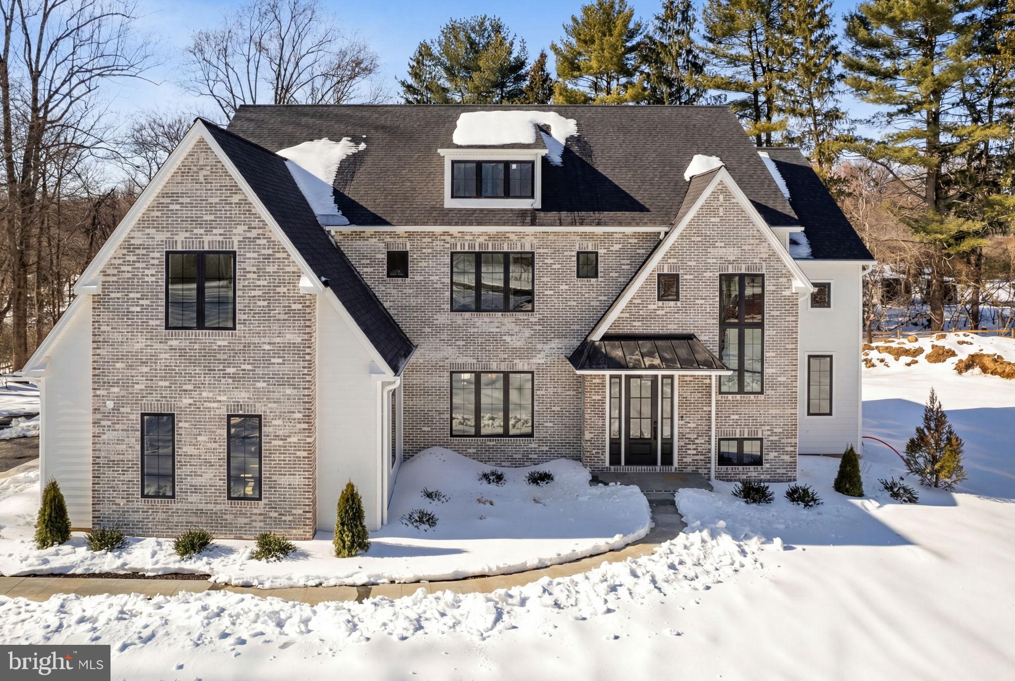Private. Brand New. Move-In Ready.
A rare opportunity in Lower Gwynedd, this stunning luxury new construction is tucked at the end of a private lane, offering exceptional privacy, timeless architecture, and modern design—nearly 6,000 square feet of beautifully finished living space with nothing left to do but move in. Step inside to wide-plank European oak hardwood floors, 10-foot ceilings, and a dramatic coffered great room ceiling that instantly sets the tone for elevated everyday living. The open layout is designed for how people truly live today—connected, comfortable, and ideal for entertaining. The chef’s kitchen anchors the home with Sub-Zero and Wolf appliances and an effortless flow for hosting. Just beyond, a custom scullery/bar and secondary prep area creates a natural gathering space for cocktail prep, beverage storage, and serving—allowing the main kitchen to stay polished while the party unfolds. The space flows seamlessly to a covered veranda and expansive sundeck, perfect for indoor-outdoor entertaining, quiet mornings, or relaxed evenings with friends and family. A first-floor study with a full bath offers flexible living—ideal as a private home office or guest suite. The sun-filled finished lower level expands your lifestyle options with space for a game room, home theater, fitness studio, or wellness retreat. Upstairs, the owner’s suite is a serene, spa-inspired escape designed for true relaxation, while the junior lounge provides a stylish retreat for family or guests.
Located in the Wissahickon School District and minutes from top private schools, this home also offers exceptional convenience. Enjoy close proximity to Whole Foods, Starbucks, Ambler’s popular restaurants and boutiques, Route 309 shopping, the PA Turnpike just six minutes away, and the Ambler train station for easy commuting.
