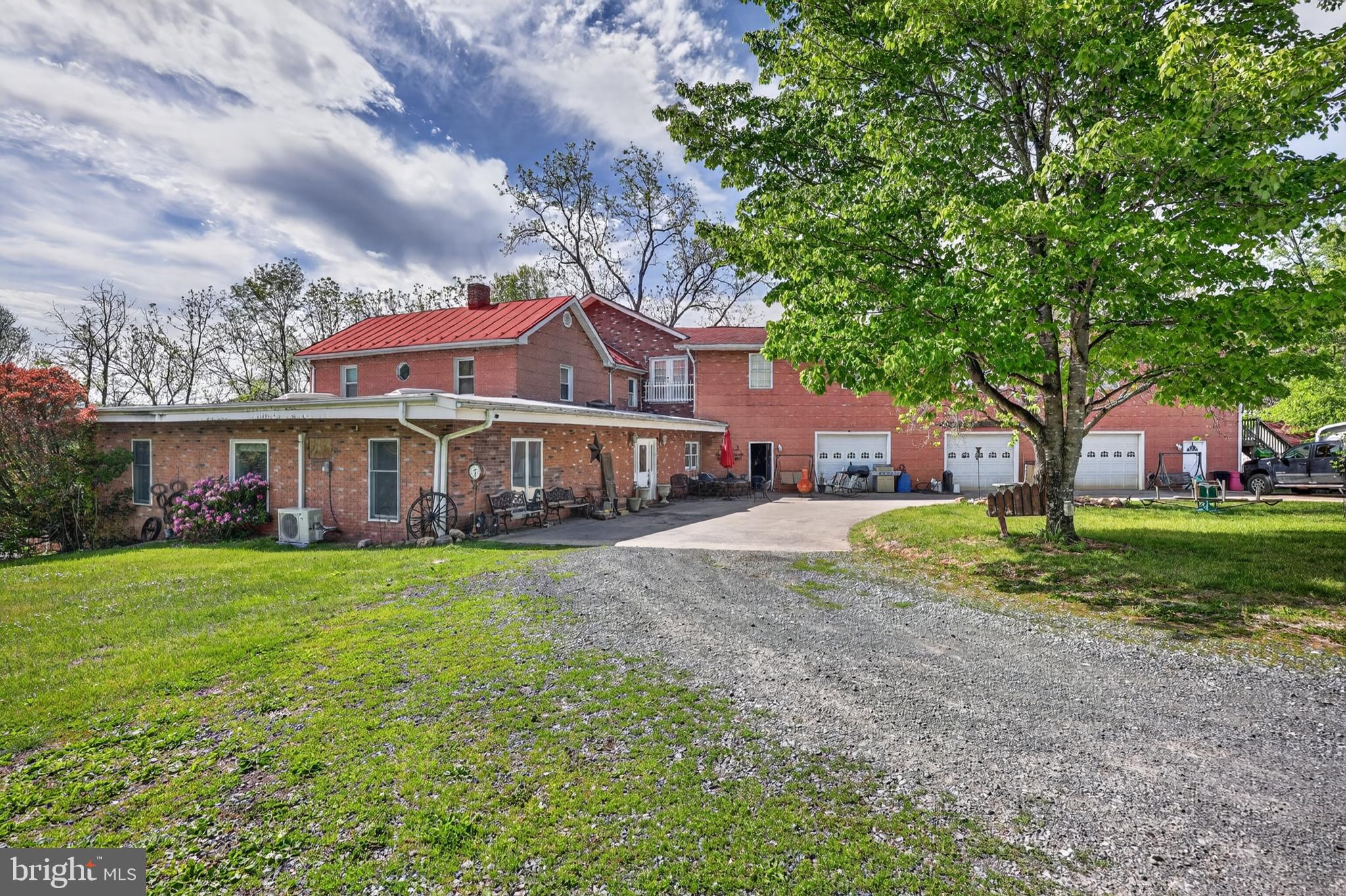 Set on nearly two private acres, this truly one of a kind property offers the perfect blend of comfortable living, outdoor entertaining, and income producing potential.  The beautifully maintained four bedroom, 2.5 bath main residence features a spacious living room highlighted by a stunning skylight, creating an open and light filled atmosphere.  The remodeled kitchen offers modern updates and functional space ideal for everyday living and entertaining alike. 
Step outside to a large rear deck overlooking the fenced in ground pool and pool house, creating a private backyard retreat perfect for gatherings, summer relaxation, or entertaining guest.  Connected to the property is an impressive three bay garage with space for up to six vehicles, ideal for car enthusiasts, hobbyists, or additional storage needs.
Above the garage are two separate, two bedroom one bath apartments, both currently rented on a month to month basis and generating $2,650 per month in rental income.  Whether you are looking for a multi-generational setup, investment opportunity or supplemental income, this unique arrangement offers exceptional flexibility and value.
With its combination of residential comfort, outdoor amenities, expansive garage space, and built in rental income, this rare property delivers endless possibilities in a peaceful setting with room to enjoy.