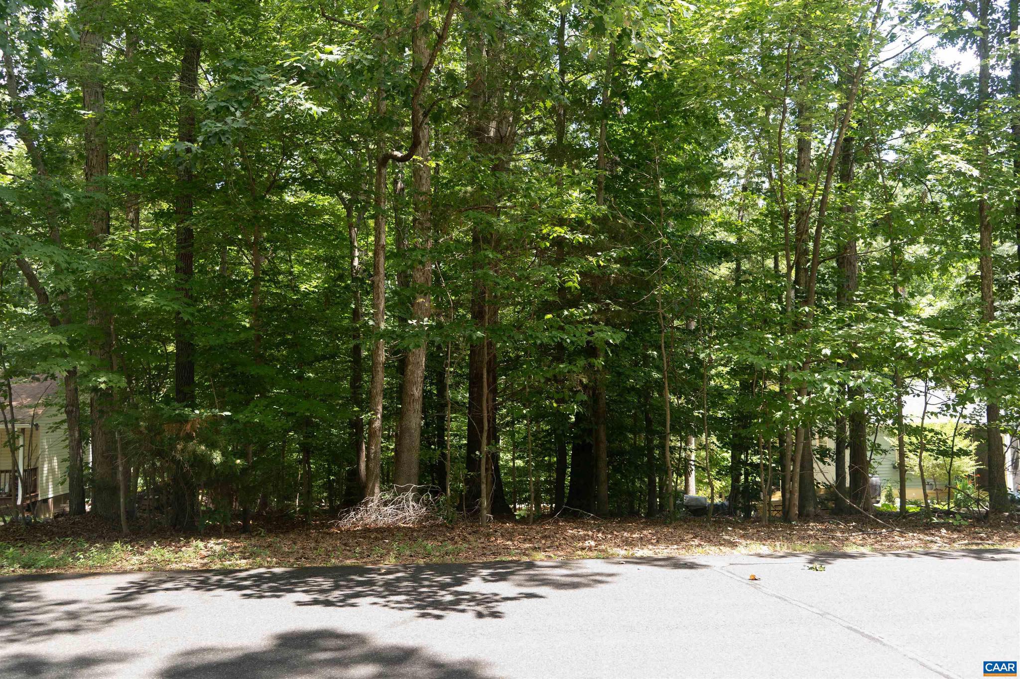 Build your picture perfect home at Lake Monticello! This land is ideally located on Bolling Circle, just inside the main gate. Just a short walk (or 3-minute drive) to some of Lake Monticello's best known amenities including Beach 1, the pool, Ashlawn playground, basketball & tennis courts, and the marina. This property is nearly level to gently sloping with mature trees. Enjoy life at the lake under 30 minutes to downtown Charlottesville.
