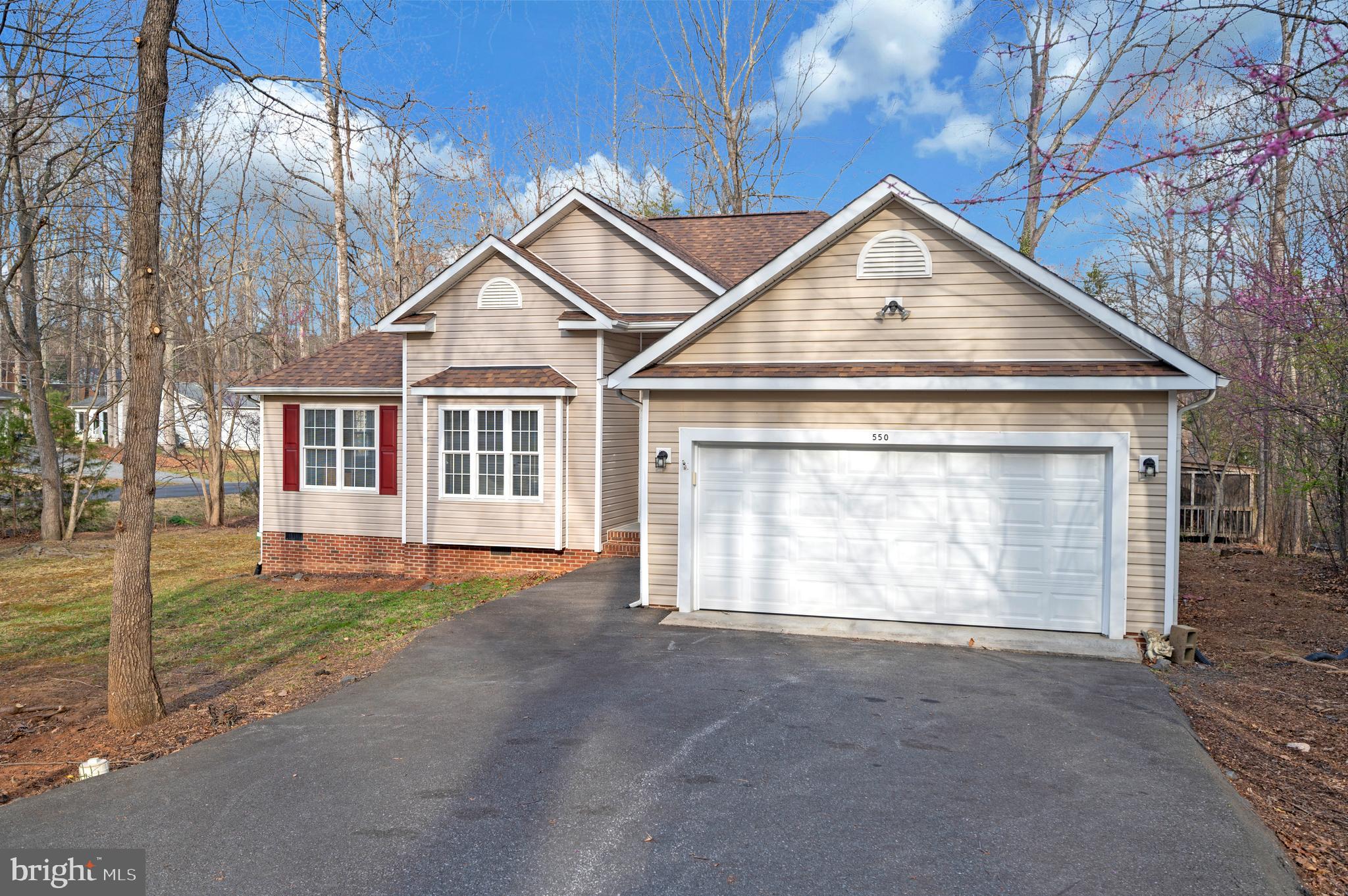 Situated on a corner lot at Harrison Circle and Stratford Circle in Lake of the Woods, 550 Harrison Circle welcomes you with hardwood flooring that sets the tone as you enter. The spacious living room with vaulted ceiling offers a comfortable gathering space, complete with a fireplace and two doors on either side that lead out to a covered, screened-in deck, creating a natural extension for indoor and outdoor living. A formal dining room provides an additional area for hosting, while carpeted flooring adds warmth to the main living spaces and all bedrooms.

The primary bedroom is well-sized and thoughtfully positioned on the opposite side of the home from the additional bedrooms, offering a sense of privacy. It features a sliding glass door that opens directly to the screened-in deck, along with an ensuite bathroom that includes luxury vinyl plank flooring, double sinks, a walk-in shower, a separate soaking tub, and a spacious walk-in closet.

Bedrooms two and three are slightly larger than standard and offer flexibility for use as guest rooms, family spaces, or hobby areas. The kitchen provides ample countertop space and abundant cabinet storage, along with a convenient breakfast bar and a smaller adjoining dining area for everyday meals. Large windows fill the kitchen and dining area with natural light while offering views out to the back deck.

With its thoughtful layout, generous living spaces, and seamless connection to the screened-in deck, this home offers both comfort and versatility for everyday living. The combination of privacy, natural light, and inviting indoor and outdoor spaces creates an environment that is easy to enjoy and well-suited for a variety of lifestyles.

Nestled in a private, secure, gated community, Lake of the Woods is a paradise of possibilities. With two lakes, a golf course, an equestrian center, fire and rescue services, and even a church within its bounds, this community offers a diverse range of activities. From boating, water skiing, kayaking, and golfing to the simple joy of soaking in mesmerizing views from the clubhouse, deck, yard, or beaches, there's something for everyone. Engage your interests by joining over 60 clubs and organizations, or perhaps indulge in a game of bridge or contribute your talents as a volunteer. Lake of the Woods truly caters to your lifestyle.

Located in Orange County, enjoy the added advantage of low real estate taxes. With home prices spanning from $200,000+ to over $2,000,000, Lake of the Woods is the ideal haven for both full-time residents and weekenders. Don't just take my word for it – come and see for yourself! Allow me to guide you through a tour of Lake of the Woods, showcasing the very essence of what makes this community so special. Experience firsthand the captivating charm of Lake of the Woods!