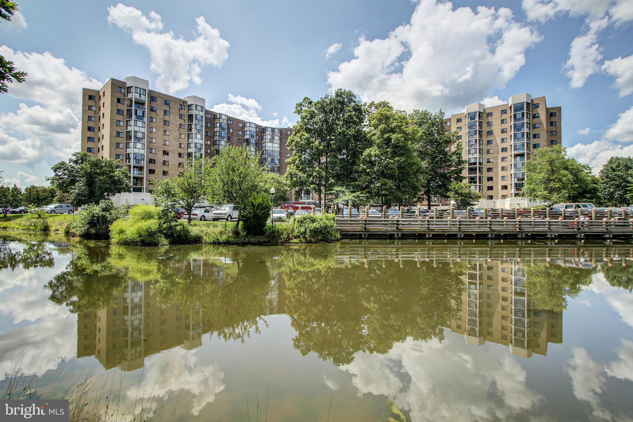 NEW PRICE!!! Beautiful top floor 2 bedroom and 2 full bathroom condo with spectacular views of water and golf course. Move-in ready.  Recent improvements - carpet,  floors, fresh paint, light fixtures, appliances & vanity mirrors. Large walk-in closet with amazing custom built-ins. Large kitchen with pantry. Beautiful sunroom with jaw dropping views.  Garage parking and also a storage room.  55+ community.