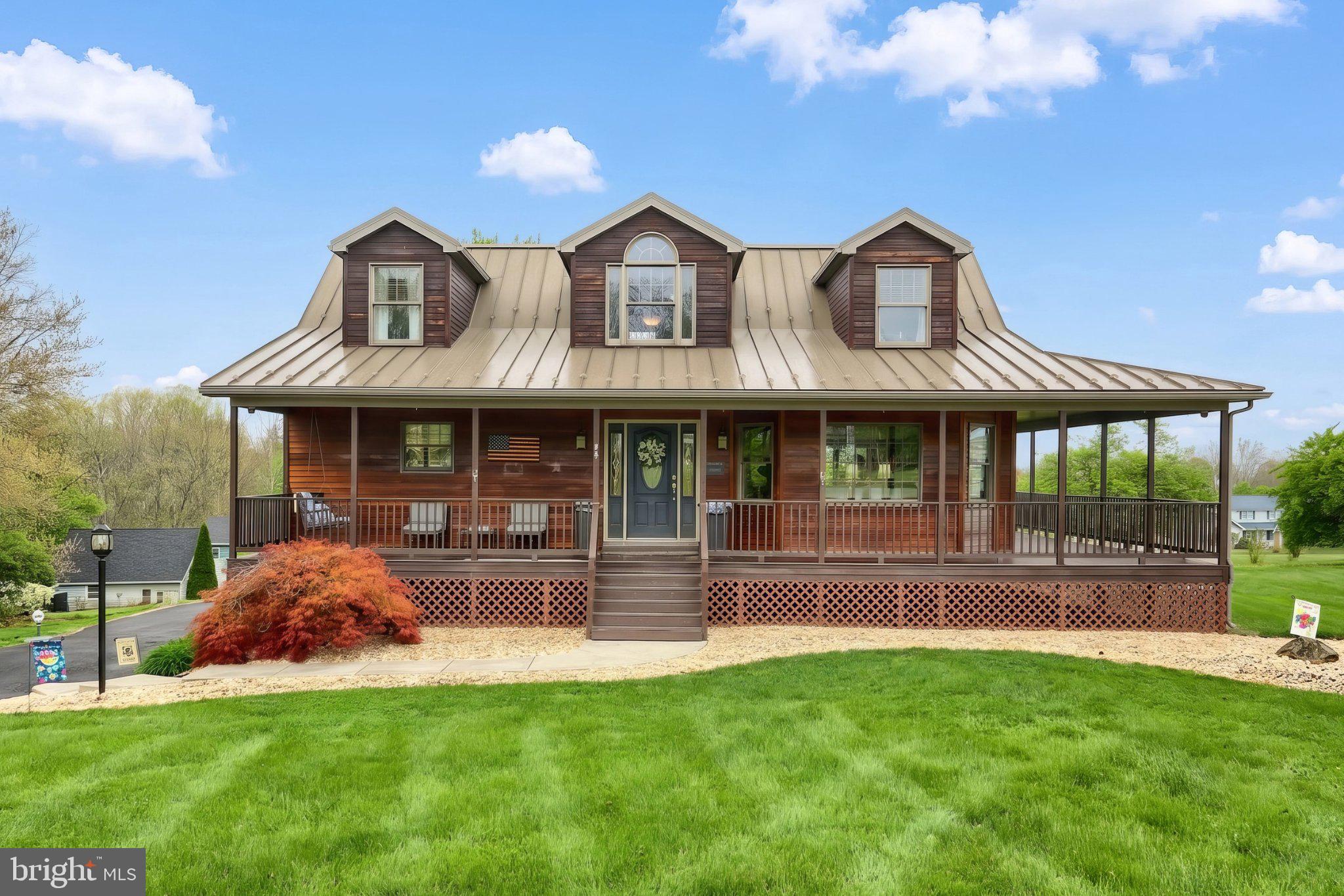 Embrace the lake life! This stunning Cape Cod-style residence offers a harmonious blend of luxury and comfort, perfect for those seeking an elevated lifestyle. Spanning a generous 0.37 acres, the property boasts stunning views of the tranquil waters of Lake Meade, inviting you to unwind and embrace the beauty of nature right from your own front porch. Step inside to discover an open floor plan that seamlessly connects the living, dining, and kitchen areas, creating an inviting atmosphere for both relaxation and entertaining. The heart of the home features a  kitchen equipped with stainless steel appliances, including a built-in microwave, dishwasher, and stove, complemented by an island that serves as additional countertop space. The combination dining/living area is accentuated by warm wood floors and a cozy fireplace, ideal for creating cherished memories with loved ones. Retreat to the luxurious primary suite on the main level, complete with a walk-in closet and an en-suite bathroom that boasts a soaking tub and a walk-in shower, providing a spa-like experience at home. The partially finished basement offers versatility, featuring an additional family room, a half bath, a sauna, garage access, and a walkout to the expansive fenced rear yard, perfect for outdoor gatherings or quiet evenings under the stars. Enjoy the wrap-around porch where you can sip your morning coffee while soaking in the picturesque lake views or the lower level patio where you can overlook the more private rear yard. This property is not just a home; it's a lifestyle. The community amenities include a pool, tennis courts, and more, providing endless opportunities for recreation and relaxation. With the monitored community entrance ensuring peace of mind, you can fully embrace the exclusive lifestyle that Lake Meade offers. Additional features include a two-car attached garage, ample driveway parking, and a charming shed for extra storage. The home is wired for a generator and the portable generator currently owned by the sellers will remain for the new owners. Experience the perfect blend of luxury, comfort, and community in this stunning Lake Meade residence, where every detail has been thoughtfully designed to create a warm and inviting sanctuary.