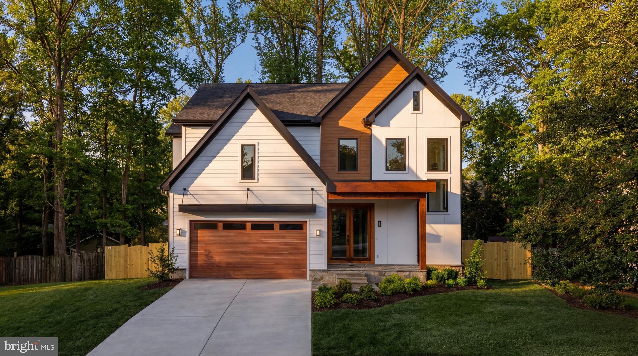 Gracefully set along a wooded cul-de-sac just blocks to downtown Vienna, 913 Symphony Circle Southwest is a new modern Craftsman residence meticulously envisioned and crafted by Luka Design & Build. Blending architectural sophistication with warm, livable design across 6,550 square feet over three finished levels, the home is distinguished by curated materials, layered lighting, and refined millwork that create an atmosphere of understated luxury.

Striking double front doors introduce an elegantly deep foyer defined by a curved tray ceiling with soft indirect illumination, establishing the home’s ethos. Wide-plank solid hardwood flooring flows throughout the main level, past sliding gridded glass and metal doors leading into the office with custom built-ins and integrated LED lighting. The formal dining room opposite the foyer showcases craftsmanship with double wall picture frame molding and a matching backlit ceiling cove.

The central living spaces unfold with effortless continuity. Anchored by custom built-ins and a statement fireplace, the family room balances comfort and scale while maintaining strong visual connection to the outdoor living areas. Expansive glass doors lead to a screened porch, extending the home’s entertaining potential and creating a seamless all-seasons indoor/outdoor experience.

Designed with both form and function in mind, the kitchen showcases custom designer cabinetry, indirect ceiling and toe-kick lighting, and a full professional-grade JennAir appliance configuration. An ample walk-in pantry, oversized island with reeded wood ends, and adjacent breakfast area support casual living, while a well-appointed mudroom with built-in bench and cubbies provides organization and direct access to the two-car garage. A beautifully finished powder room and thoughtfully placed main-level bedroom suite enhance both the guest experience and the home’s multigenerational capabilities.

An intimate sitting area is nestled at the top of the grand staircase, from which upper-level spaces branch. The primary suite is the highlight, entered through double doors and defined by an uplit tray ceiling and feature headboard wall. A boutique-like dressing room showcases extensive illuminated built-ins. The spa-like primary bath features a wet room with a Kohler Anthem shower system, separate soaking tub, illuminated niche, double vanity, and private water closet. Three additional bedrooms are generously sized with walk-in closets and ensuite baths, while a well-equipped laundry room completes the upper level.

Designed for entertaining, the walkout lower level is an amenity-rich space. A designer wet bar anchors the entertaining area, backed by a dramatic arched recess with floating shelving. A professional media room, fitness room, and full bedroom suite complete the level.

Beyond its aesthetic appeal, the home incorporates numerous infrastructure upgrades, including dual-zone Carrier HVAC systems, Andersen windows and doors, a 75-gallon water heater, and prewiring for security cameras and whole-home audio. Out back, the fully fenced rear lawn is both private and usable, shaded by a towering verdant canopy.

Enhancing the home’s lifestyle appeal, the property conveys with a coveted membership and stock certificate to Vienna Woods Swim and Tennis Club, located just a one-minute walk away. One of Vienna’s most sought-after community clubs, it features a vibrant neighborhood atmosphere, resort-style pool, and new tennis facilities. Memberships are rarely available due to a 10-year waitlist, making this transferable membership a valuable benefit for the next owner.

Combining modern craftsmanship and refined architectural detail with an exceptional close-in location, 913 Symphony Circle is a rare example of an uncompromised residence.