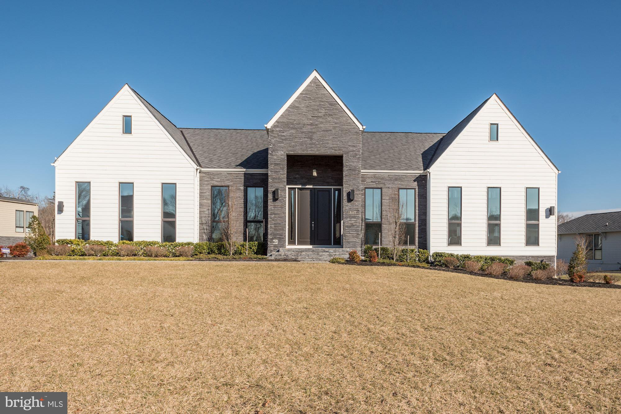 The Noorderwind: a Luxurious Line-K contemporary home by Dutch designer Piet Boon. When you enter this modern interpretation of the historically inspired farming architecture of the Willowsford neighborhood, you ll be awestruck by the 12 foot ceilings, 10 foot doors, & luminous natural light from the 10 foot floor to ceiling windows. Entertain your guests on a 13 ft long Quartz waterfall island with food prepared by Viking appliances.Blur the lines between the outdoor & indoor with the glass multi-slide pocket patio doors. The fully retractable doors open the entire living room to flow right onto the covered porch to a tranquil view of a large open yard that backs to the woods. Why wait to have one built when you can have this home with over $150K in options, NOW. Options include Stone Porch veneer, Stone foundation veneer on all sides, oversized custom shower, walk-out basement w/patio. With over 8,200 sqft of finished living space and over 1,000 sqft of unfinished space, there s still room to grow! BE SURE TO CHECK OUT THE 3D TOUR!