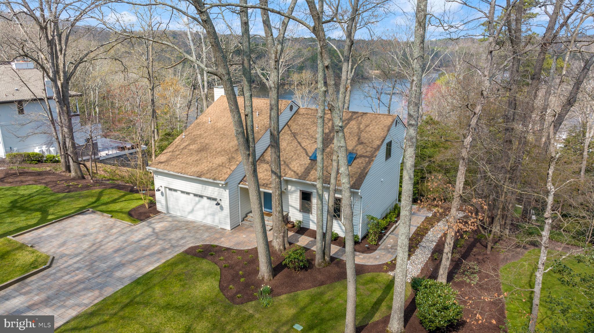 STUNNING ONE-OF-A-KIND PROPERTY!  WATERFRONT HOME IN SOUGHT AFTER INDIAN LANDING COMMUNITY!  VIEWS OF THE SEVERN FROM EVERY LEVEL WITH THE MOST BREATHTAKING SUNSETS YOU'LL EVER WANT TO SEE!
This recently renovated home has an amazing location approximately 20 minutes from Annapolis and BWI airport.  The home features three-levels with water views everywhere, open floor plan that boasts four bedrooms, three full and one half baths. 
The extensive renovations impressively include Anderson windows and all new copper piping throughout home. 
When you pull onto the property you will immediately notice the professional hardscape/landscape with paver driveway that can fit six vehicles.  Automatic sprinklers in front help keep the landscape lush. Two car garage has newer epoxy floor which opens to the living space for easy access to get groceries from car to kitchen.  From the front porch you can see the wooded property of Arlington Echo which offers a secluded private feel.  Towards the end of the street is where you will find the marina and Indian Landing boat club.  Every space of this home was thoughtfully and meticulously updated giving a modern style and warm sophistication. 
On the main level, you will love the two-story ceilings with skylights over the full dining room with elegant modern teardrop style light feature and soft natural light, the gourmet kitchen with its scenic water views and amazing nine foot modern Quartz island, nicely finished with stainless steel electric Bosch appliances and recessed lighting!  The main living area offers an updated comfortable style, custom lighted shelving, and a warm cozy gas fireplace. The living area has sliding glass doors leading to a covered screened-in sitting area overlooking the beautiful Severn River.  Off the kitchen is a main level bedroom currently used as an office. 
The upper level was completely updated offering engineered hardwood floors, updated trim and doors, three bedrooms (one currently being used as a home gym), two full baths, a new laundry room boasting amazing quartz counters, storage , modern cabinetry, full sink, and a beverage refrigerator. The primary bedroom boasts a recently renovated en-suite bath with glass shower doors, tile floors and quartz counter; includes a large walk-in closet with custom closet organizers, a warm cozy gas fireplace, and a private balcony. 
The lower level has been completely renovated to include luxury vinyl tile floors, a living room, a bonus room currently being used as a spacious bedroom, a full bathroom with tub, a flex room with storage closet, and a walkout to the paver patio and extensive yard leading to the water.  The lower level has in-law potential with everything being there except a 2nd kitchen.
The whole home has been recently painted inside and out giving the entire home a new feel. 
The upper and main levels boast beautifully engineered hardwood floors throughout which really give an elegant warmth to the entire space.  The exterior waterfront portion of the home features: a covered stand up paddle board rack (SUP), a new staircase with patio deck, the refurbished pathway has been accented with LED lighting, the pier was extended at the end to allow for sitting area with updated deck boards where needed.  The pier has water, electricity, two electric boat lifts and floating dock for easy access or for use with water sport.  The channel was recently government dredged.
All the hard work has already been done!  This is a waterfront enthusiast’s dream with a westerly view of the Severn offering the most stunning sunset views on the river from every level!
**If interested, the seller will consider selling furnitured**