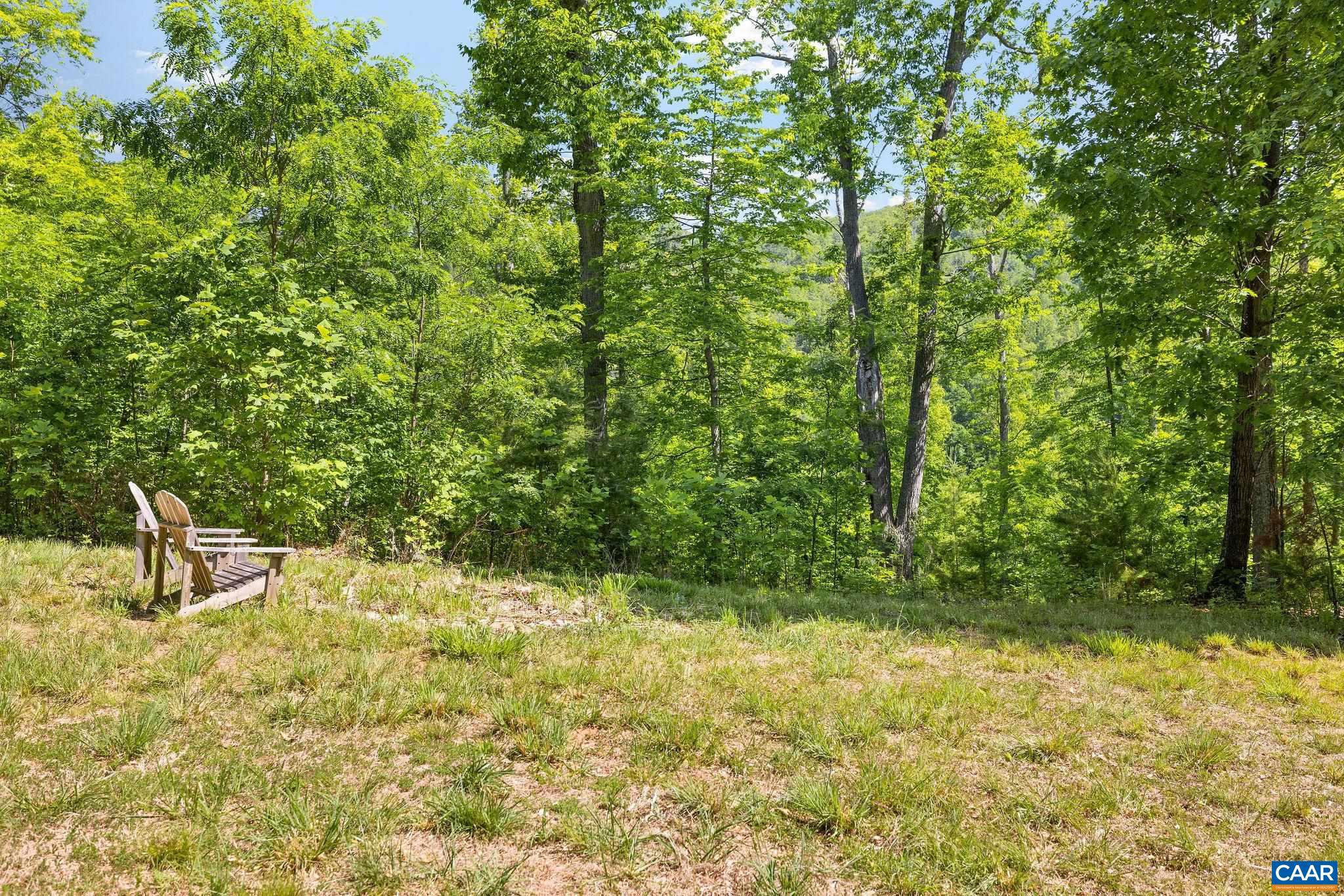 This extraordinary parcel offers rare privacy and natural beauty just minutes from town. Part of over 1,200 contiguous acres in conservation easement and near the Ragged Mountain Reservoir, the property feels like a true retreat, yet is only 10 minutes to the University of Virginia, shopping, and dining. A thoughtfully prepared homesite is already in place, including a quarter-mile driveway (2020), a cleared building site with private views, a drilled well (2021), and a secured power easement. One of the headwaters of Moores Creek runs through the land, adding to its natural appeal. The property also borders other fine estates and sits just across Route 29 from Potter?s Craft Cider. The land features a trail leading to one of the property's highpoints, as well as another short trail to a unique rock outcropping. Rich with wildlife (including deer, bear, bobcat, and turkey), this is an ideal setting for hiking, mountain biking, and quiet enjoyment under expansive night skies. With significant groundwork complete, this is a rare opportunity to create something truly special in one of Charlottesville?s most protected and scenic landscapes.