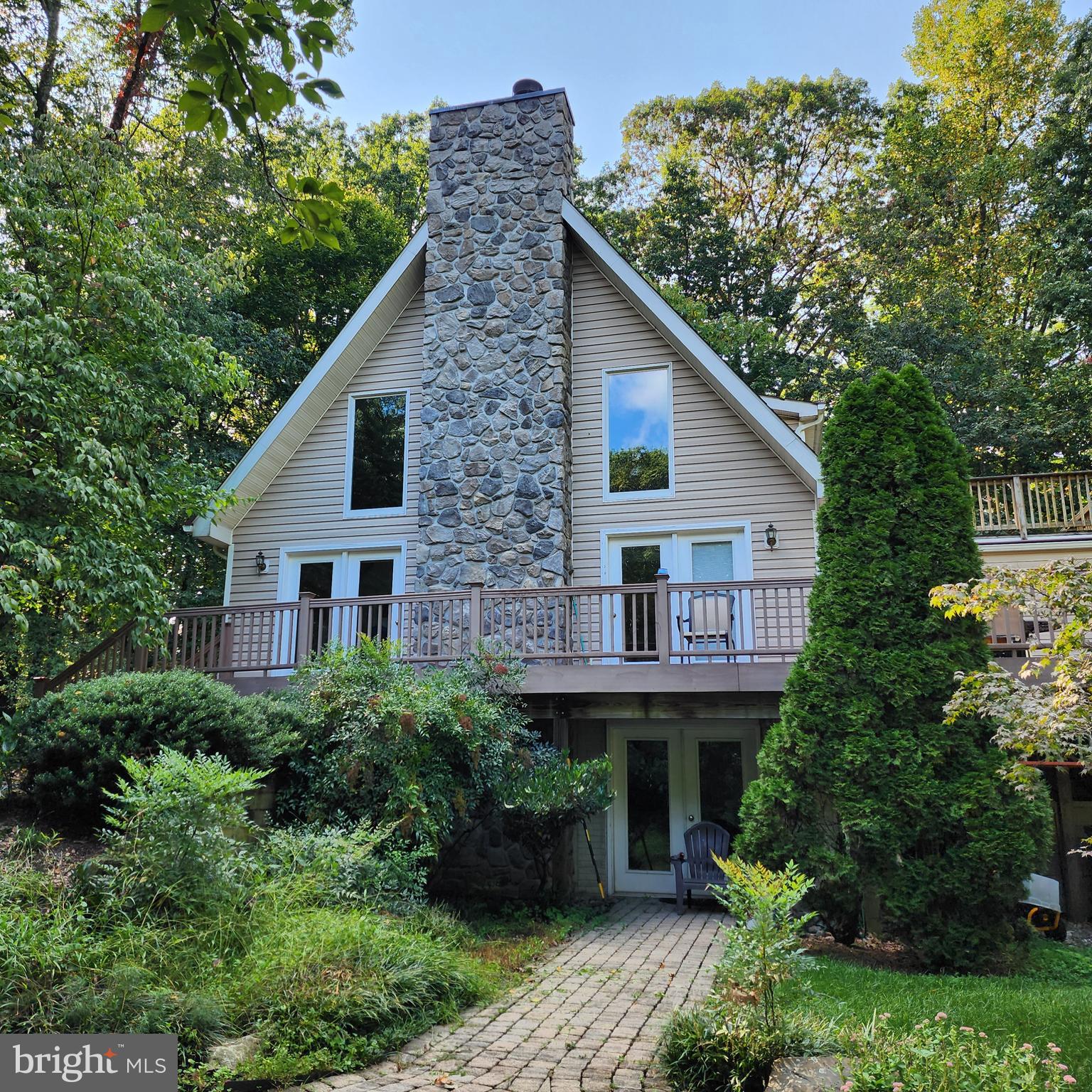 Price reduced! Just over 3,500 finished sq/ft on three levels. Beautiful 5.89 acre mostly wooded lot. Inground pool for coming summer fun. Large synthetic wrap around deck with patio and pergola behind.  Dramatic floorplan. Nothing else like it! Looking for main level bedrooms? We've got them. Large primary bedroom on second level. Private second level deck. Dramatic open great room with tongue and groove wood ceiling. This property has a Classic titanium enhanced outdoor wood furnace that can heat the house, hot water and, during season even take a chill off the inground pool.