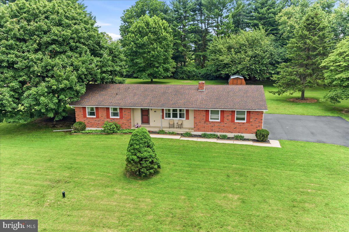 Welcome home to this well-built brick ranch nestled on a beautiful, level 1-acre lot in one of the area's most desirable locations. Offering the perfect blend of solid construction, timeless character, and endless potential, this lovingly maintained home is ready for its next chapter. Step inside to discover hardwood floors throughout, a spacious living room anchored by a cozy wood-burning brick fireplace, and a welcoming den featuring a charming bay window, elegant crown molding, and access to the rear deck—perfect for relaxing or entertaining while enjoying the peaceful backyard. Storage is plentiful with oversized closets throughout the home, and the unfinished lower level provides endless possibilities for future living space, a workshop, or additional storage. Recent updates include a new well pressure tank (2026), newer hot water heater, and a septic system with two drain fields for added peace of mind. While the home offers an excellent opportunity for cosmetic updates, it has been exceptionally well cared for and is completely move-in ready. Enjoy the freedom of **no HOA**, a convenient location just minutes to Delaware, and in the highly sought-after Avon Grove School District. Whether you're looking to personalize your forever home or invest in a property with outstanding bones in a prime location, this sturdy brick ranch is a rare find that shouldn't be missed.