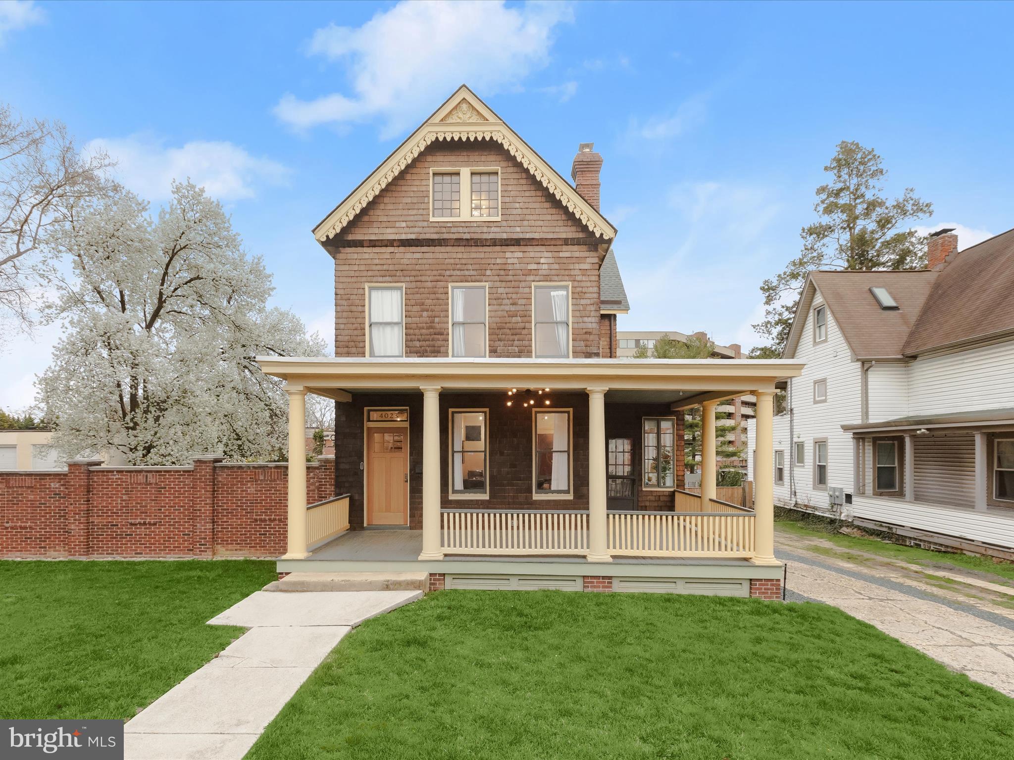 Located in sought-after Roland Park, this exquisite five-bedroom, four-full and one-half bathroom Victorian home has been completely renovated throughout, blending historic charm with exceptional modern updates. Situated on an expansive 0.37-acre lot with both side and back yards, this four-level home showcases impeccable craftsmanship and thoughtful design at every turn. As you arrive, a front yard and a wrap-around porch offer a warm welcome. Inside, wide live sawn solid white oak flooring spans the main and upper level, complementing the abundance of natural light, modern accent wood panel walls, and upgraded lighting with dimmers. A decorative brick mantel adds warmth to the front living room, while the adjacent gourmet kitchen impresses with high-end Fisher Paykel® appliances, a wall oven, a gas cooktop with a downdraft, and custom cabinet door panels that conceal appliances. A butcher-block island with end grain white oak cutting boards, bar seating, and pendant lighting creates a striking centerpiece, while soft-close cabinets with dovetail white oak pull-out drawers, a built-in pantry, and a copper farmhouse sink enhance both style and function. The dining area is perfect for gatherings, while the cozy family room features double glass doors leading to the back wrap-around porch for seamless indoor-outdoor entertaining. A full bathroom with a walk-in shower, a mudroom with a side door to the driveway, and a charming sunroom ideal for an office or lounge complete the main level. Upstairs, the primary bedroom suite boasts reclaimed heart pine flooring, floor-to-ceiling paneled walls, and exposed beams that accentuate the soaring cathedral ceiling. Indulge in the spa-like ensuite bathroom, showcasing a frameless glass Mr. Steam walk-in shower and a luxurious soaking slipper tub. A custom walk-in closet adds to the retreat-like feel. Down the hall, the second bedroom suite includes a private bathroom with a frameless walk-in shower and a French glass panel. A convenient laundry room and an additional hall full bathroom with a tub shower complete this level. Up one more level, the top floor features three additional bedrooms. Downstairs, the unfinished lower level offers generous storage space and a half bathroom. Outdoor living is equally impressive, with expansive wrap-around porches and a backyard designed for both relaxation and play, featuring a playground and ample space for everyone’s activities. Rear parking accommodates at least ten vehicles and includes a convenient storage shed.