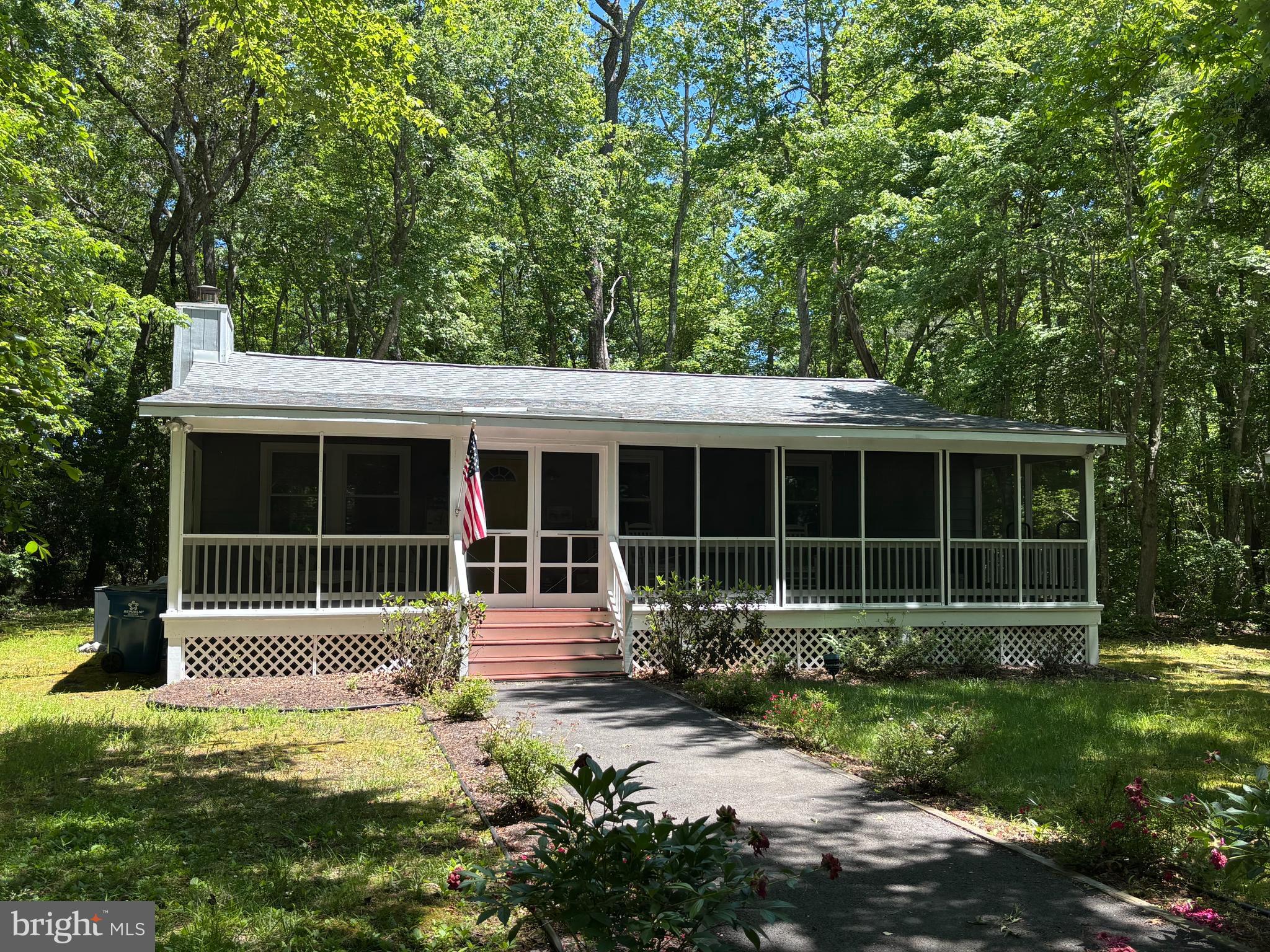 Welcome to your private retreat in the heart of Ocean Pines! Set on a serene, maturely wooded, this beautifully maintained 3-bedroom, 2-full-bath home offers the perfect blend of comfort, privacy, and convenience. The standout feature is the expansive screened porch, where you can enjoy morning coffee, evening breezes, and peaceful wooded views in every season. Inside, the bright, open-concept living and kitchen area is designed for both everyday living and entertaining. A cozy wood-burning fireplace creates a warm focal point for relaxing after a day at the beach or on the golf course. The thoughtfully designed layout feels spacious and functional throughout. Sliders open to a rear deck and a large yard complete with a freestanding storage shed, providing plenty of room for outdoor living and all your beach gear. Recent upgrades include a newer roof and HVAC system, offering added peace of mind. Located just minutes from Ocean Pines' exceptional amenities, including championship golf, marinas, yacht club, pools, parks, walking trails, and racquet sports facilities, this home also offers easy access to Ocean City's beaches, boardwalk, dining, and entertainment. Whether you're seeking a year-round residence, vacation getaway, or investment opportunity, this coastal gem is ready to welcome you home.