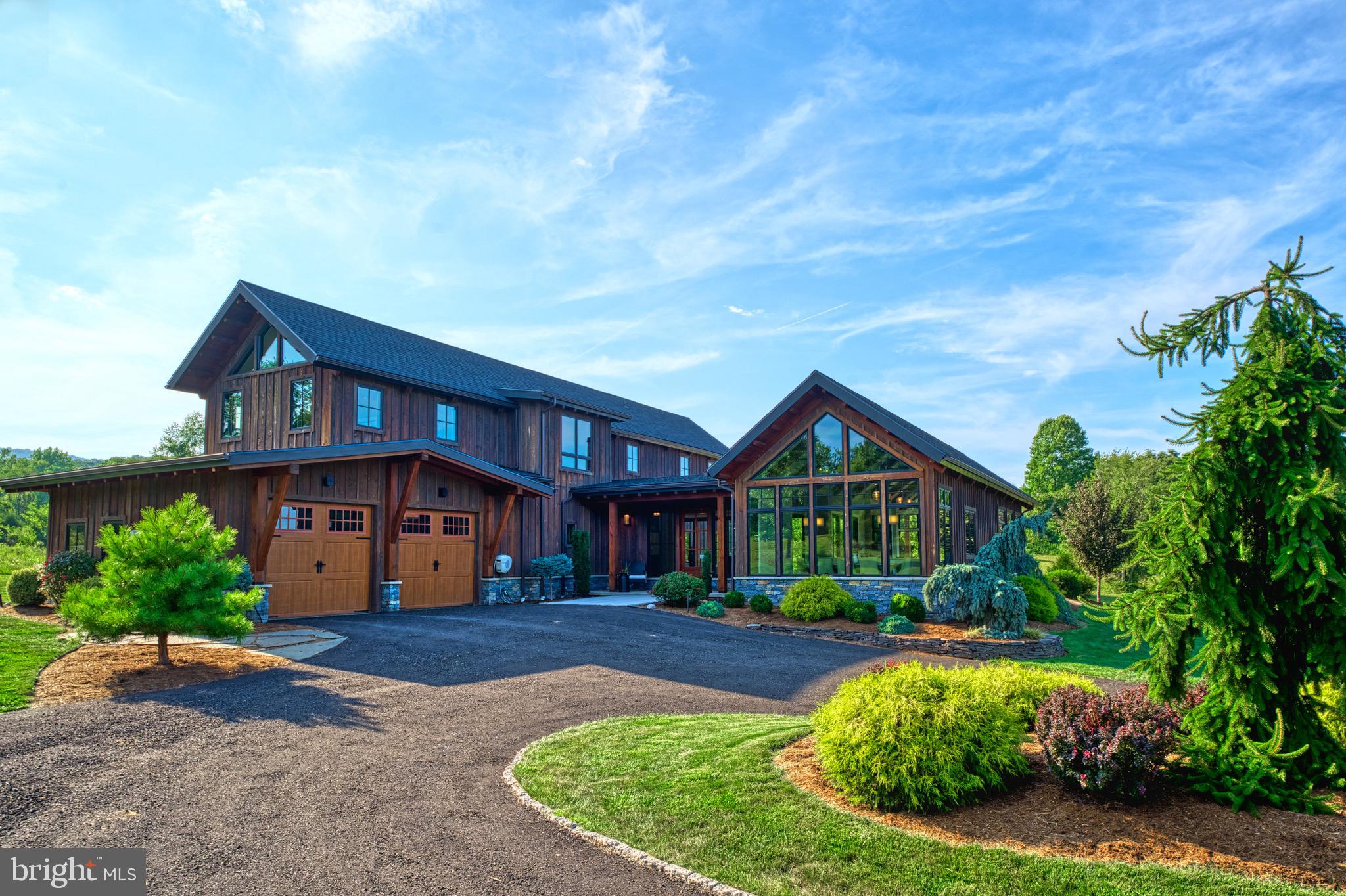 Welcome to Timber Ridge Estate.  Experience the ultimate in luxury and seclusion with this stunning custom timber frame home, set back along a long private driveway on over 12 pristine acres. This extraordinary residence features three spacious suites, each offering privacy and comfort. The home is designed to bring the outdoors in, with expansive large windows and doors that flood the interior with natural light and offer breathtaking views of the surrounding mountainous landscape. This home is a true masterpiece of luxury where every detail has been meticulously crafted with no expense spared. This home is designed for those who seek the serene embrace of nature without compromising on the luxurious comforts of modern life. Constructed with the finest materials sourced from across the country and brought to life by skilled artisans, it exemplifies unparalleled quality and craftsmanship.  From the grand entrance to the inviting family room, every corner of this residence is a testament to beauty and perfection.

The home has two wings, the living quarters and the sleeping quarters, beautifully separated by a grand foyer. The living quarters are nothing short of spectacular, featuring expansive custom Anderson windows that frame the natural surroundings, a gourmet kitchen designed for culinary enthusiasts, custom-made hickory hardwood floors, and a soaring cathedral ceiling. The open yet cozy layout creates an inviting atmosphere, ideal for unwinding after a long day.

Just down the hall, you'll find the sleeping quarters, which include three luxurious bedroom suites. The primary suite, conveniently located on the first floor, boasts a fireplace, a spacious walk-in closet, and a spa-like bathroom with a soaking tub. Upstairs, the sleeping quarters continue with two additional suites, each with its own private bathroom and cathedral ceilings. Adjacent to these suites is a cozy family room and a charming balcony, providing a perfect retreat within the home.

The beauty extends seamlessly outdoors, where a nearly 1,100-square-foot courtyard and patio create an inviting space for relaxation and entertainment. A top-of-the-line hot tub beckons you to unwind under the stars, while the covered seating and dining area, just off the grand foyer, features a 14-foot sliding glass doorway that effortlessly merges indoor and outdoor living. This home is designed for those who love to entertain family and friends, offering a perfect blend of elegance and comfort.

Explore the serene walking trail through the woods, where you're likely to encounter abundant wildlife, including frequent visits from deer and bald eagles. This home is a rare gem, offering a peaceful retreat that harmonizes with nature while providing all the luxurious amenities you could desire.  The home is conveniently located just minutes from Interstate 70 and only 90 minutes from downtown D.C. and Baltimore, it offers an easy commute or a perfect weekend getaway. Don’t miss the opportunity to experience this extraordinary home—call today to schedule your private showing.