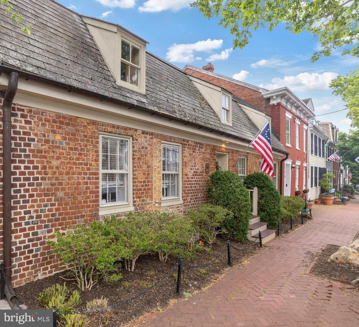 RARE OPPORTUNITY TO OWN A REMARKABLE PIECE OF ANNAPOLIS HISTORY! The Patrick Creagh House c. 1740 (also known as 160 Prince George Street) is an architecturally significant residence with a gambrel roof structure and features header and English bond brick walls. This property has been thoughtfully adapted for modern living while preserving its timeless character and craftsmanship. Ideally located in the heart of Annapolis just one block from the US Naval Academy Gate 1, City Dock, Main Street and the Maryland State House, this exceptional home offers the best of historic charm and downtown convenience. A welcoming center hall introduces spacious living and dining rooms designed for both elegant entertaining and comfortable everyday living. The private patio and garden create a serene outdoor extension of the home’s living spaces. Upstairs, the home features a primary suite with full bath, two additional bedrooms, a second full bath, and convenient laundry. The lower level provides ideal space for a wine cellar, storage, or additional utility needs. The property’s kitchen, baths and wiring have been updated and the home is move-in ready! This distinguished 18th-century property has been extensively researched and documented and is listed on the NATIONAL REGISTER FOR HISTORIC PLACES for its architectural importance and contribution to local history. Patrick Creagh was a man of many skills and was considered an important person in the community. He is mostly known for building the Old Treasury c. 1737 on the Maryland State House Grounds, the oldest public building in the state that was fully restored and opened to the public this year.
