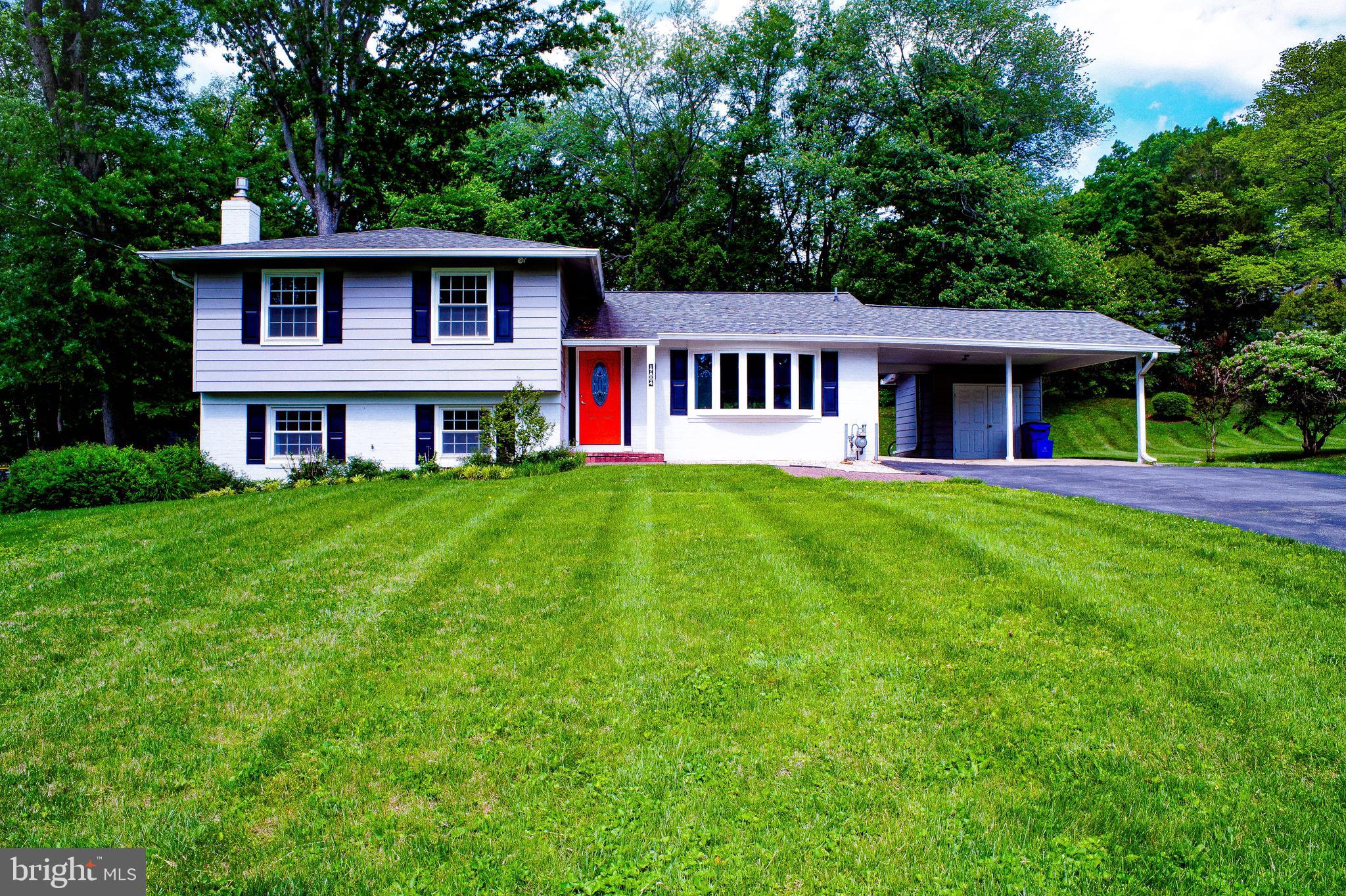 Fantastic renovations throughout, Large 4-level split model.  4 bedrooms on upper level.  Wood floors on main and upper level.  Open concept on main level with huge remodeled and expanded kitchen.  Newer stainless steel appliances, granite countertops, Large kitchen breakfast bar/island.  double sink, lots of storage space, Large pantry cabinets.  Lots of natural light.  Remodeled bathrooms throughout.  5th bedroom and 3rd full bath on basement level with separate entrance, great for in-laws, extended family, guests. Large carport offers flexibility, attached storage shed, additional concrete flooring.  Driveway is 2-cars wide and can accommodate up to 8 cars.  Mature landscaping, beautiful yard.  Bonus rear sunroom is enclosed and can be a potential 6th bedroom or second family room or home office, and has separate entrance also!  Beautiful and mature landscaping throughout the yard.
