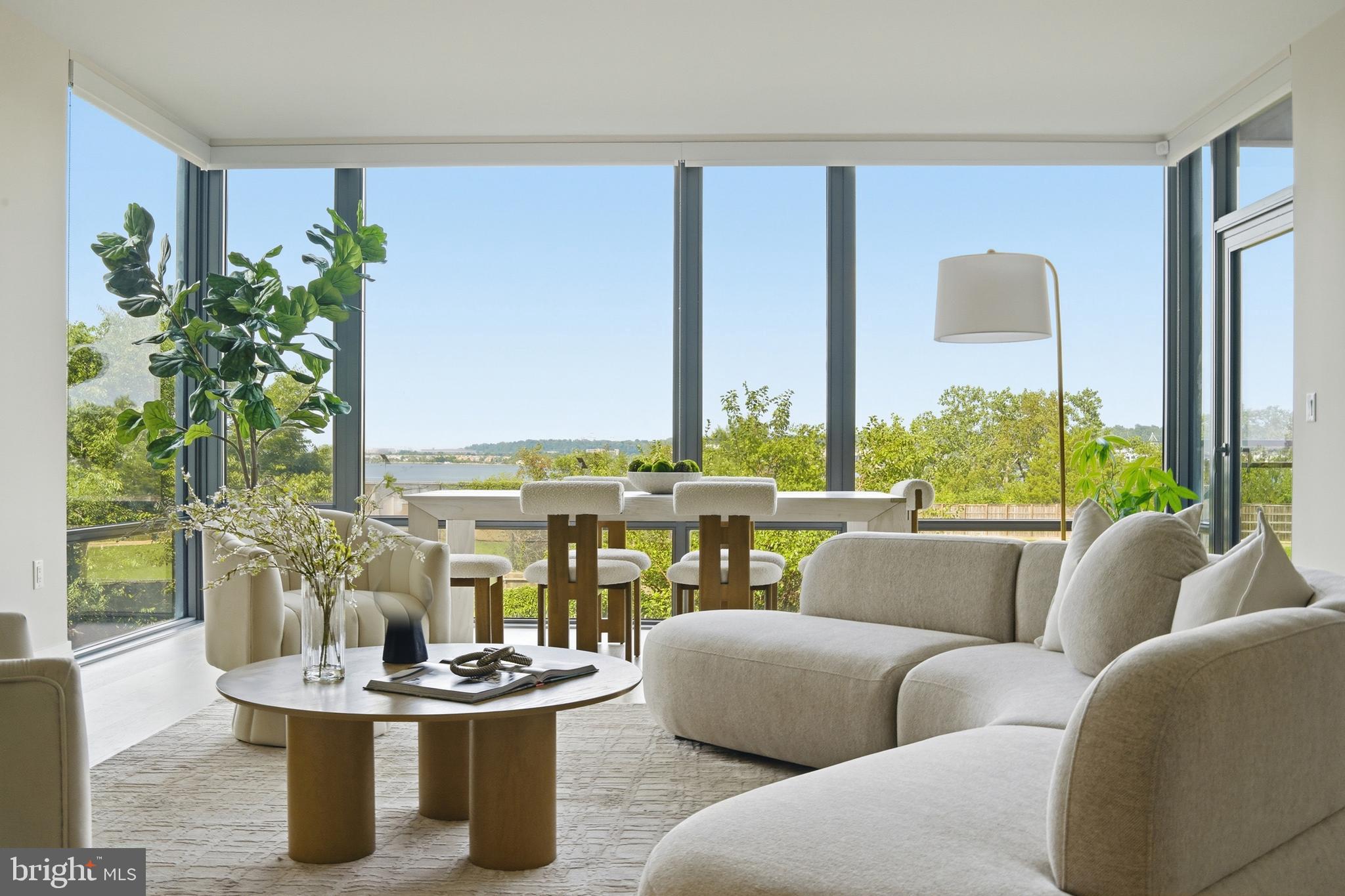 Residence 206 at the Muse is a standout offering in Old Town North, one of the most desirable waterfront neighborhoods within Old Town Alexandria, where sophisticated contemporary design, abundant natural light, and an exceptional indoor-outdoor lifestyle come together. Expansive floor-to-ceiling windows frame peaceful green space with beautiful Potomac River views, while the private balcony provides the perfect setting to enjoy morning coffee or evening sunsets.

Designed for both everyday living and effortless entertaining, the open-concept floor plan flows seamlessly between the living, dining, and kitchen spaces. The beautifully appointed kitchen features an oversized island, sleek custom cabinetry, premium appliances, and refined finishes that balance style with functionality.

The spacious primary suite serves as a private retreat with walk-through closets and a spa-inspired bath featuring dual vanities, an oversized glass-enclosed shower, and elegant finishes. Additional bedrooms provide exceptional flexibility for guests, a dedicated home office, or evolving lifestyle needs.

Residents of The Muse enjoy an exceptional collection of luxury amenities, including a rooftop terrace with sweeping Potomac River and Washington skyline views, outdoor lounge and grilling areas, a state-of-the-art fitness center, resident lounge, concierge-style lobby, secure garage parking, and private storage.

Perfectly positioned in the heart of Old Town North, this residence is moments from the Potomac River, marina, acclaimed restaurants, boutique shopping, cafés, scenic trails, and the historic charm of Old Town Alexandria. The neighborhood continues to evolve with significant public and private investment, further enhancing its appeal as one of the region’s premier waterfront destinations while preserving the walkable lifestyle residents enjoy.

Conveniently located near Reagan National Airport, Washington, DC, National Landing, and major commuter routes, Residence 206 presents a rare opportunity to own an exceptional luxury condominium where timeless design, premier amenities, and an unmatched location come together.
