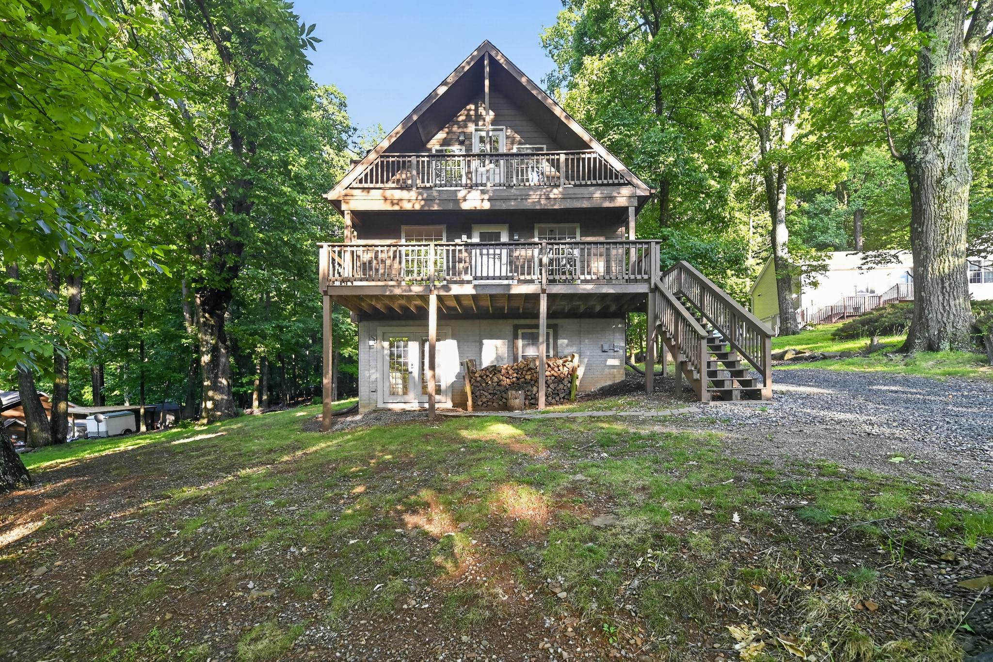 Nestled in the prestigious High Knob community, this open and airy chalet offers a blend of modern updates and comfort. Boasting a timeless architectural style and captivating cedar exterior that seamlessly integrates with the breathtaking natural surroundings. 

As you step inside, you are greeted by an inviting atmosphere enhanced by rich hardwood and ceramic tile flooring that flows throughout the main living areas. The spacious layout encompasses three well-appointed bedrooms and one and a half elegantly designed bathrooms, providing ample space for relaxation and rejuvenation. The heart of the home is the cozy living area, where a magnificent stone fireplace serves as a focal point, inviting warmth and comfort during cooler evenings. The home also features a walkout basement, offering potential for additional living space or storage, and is equipped with bathroom rough-ins for future customization. 

The property spans half an acre, offering a serene outdoor retreat with stunning mountain and valley views that create a picturesque backdrop for everyday living. For those who enjoy an active lifestyle, the community pool is just a stone's throw away, providing a refreshing escape during warm summer days. Parking is a breeze with a spacious driveway accommodating three to four vehicles (including a newly installed electric vehicle charger), ensuring convenience for both residents and guests. The property is in excellent condition with major repairs completed and systems recently inspected...allowing you to move in with ease and start enjoying the serene lifestyle it offers immediately.
