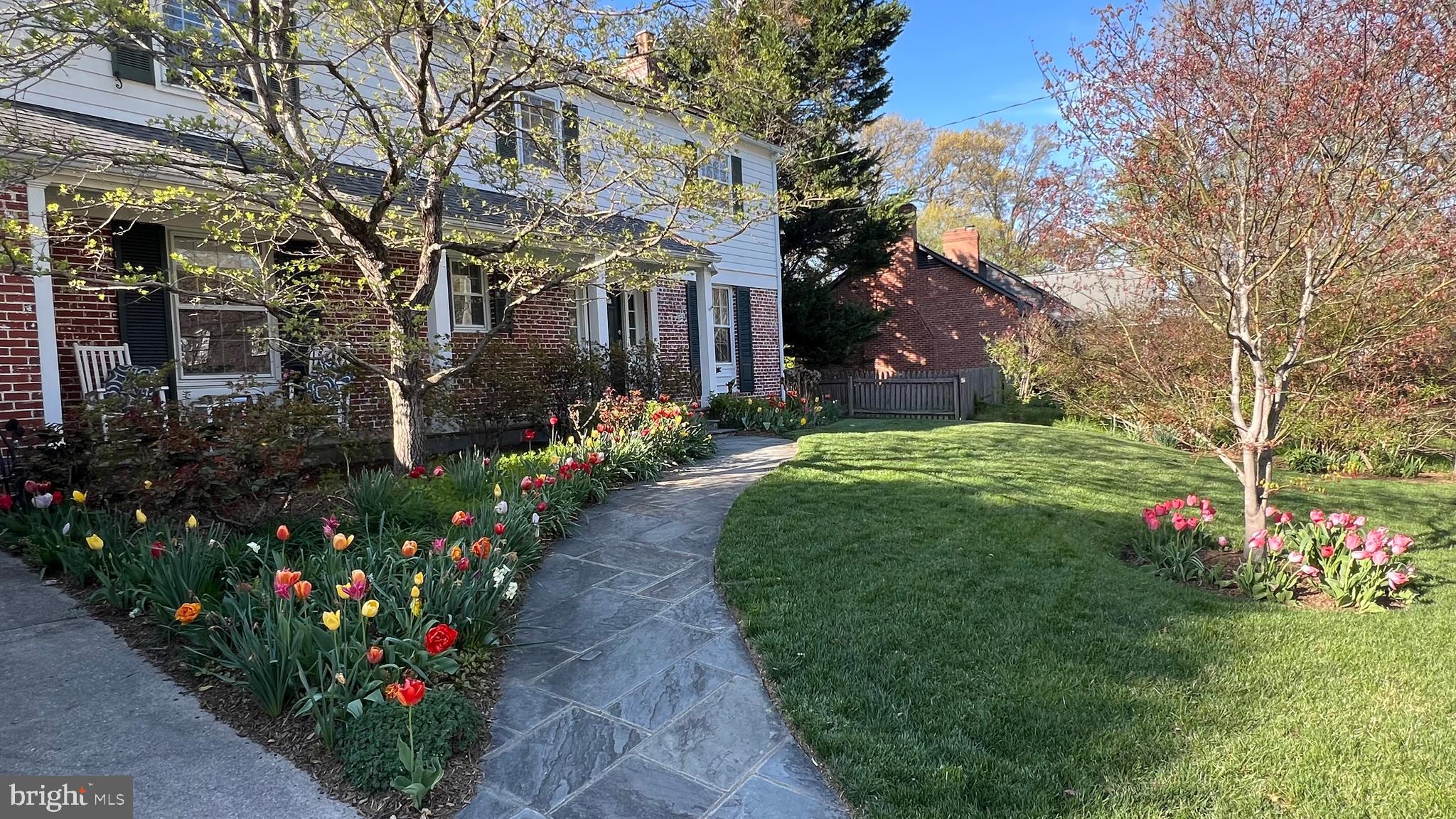 Ideally located in one of Bethesda’s most coveted neighborhoods—Fort Sumner—this stately colonial embodies timeless charm, thoughtful functionality, and meticulous care. Lovingly maintained by its owners for 27 years, the home was built in 1958 by O.F. Smith Brothers, renowned for innovative design and superior construction. Positioned on a high point in the neighborhood, the property benefits from excellent drainage and a beautifully level lot on a quiet street.

This gracious residence offers five bedrooms and features a fabulous two-story rear addition that transformed the primary suite into a true retreat while adding a spacious, sun-filled family room. The addition also expanded one of the upper-level bedrooms and added a fourth bathroom. The flexible floor plan offers a main-level bedroom or dedicated first-floor office, and the two-car garage provides direct access to the kitchen—an increasingly rare and valuable feature.

A welcoming foyer with coat closet and powder room opens to a bright, expansive formal living room featuring a wood-burning fireplace with a beautiful hearth and mantel. The formal dining room flows seamlessly into the kitchen, while stunning glass pocket doors connect to the sun-drenched family room—surrounded by windows, enhanced by recessed lighting, and anchored by a second wood-burning fireplace. This inviting space opens directly to a flagstone patio and backyard, ideal for indoor-outdoor living. The kitchen, ready for your personal touch, offers ample space for a table or potential island and includes many updated appliances. Just off the kitchen, the two-car garage provides exceptional storage with an additional refrigerator, extensive overhead and wall storage, and an attached shed for even more space.

The upper level features four generously sized bedrooms, three full bathrooms, and a large linen closet. The expanded primary suite is truly exceptional, offering abundant closet space, a sitting area with soaring ceilings, and a gas fireplace flanked by custom built-ins. The luxurious en-suite bath overlooks the backyard and includes a soaking tub, heated floors, heated towel rack, oversized shower, double vanity, and private commode. An additional flexible space is perfect for a desk, exercise area, or quiet retreat.
A walk-up attic, fully insulated and floored, provides outstanding storage and houses the second HVAC system. A solar panel system significantly reduces energy costs.
The finished lower level, perfect for a recreation or playroom, features wood beams, a custom bookcase, a third wood-burning fireplace, and walk-out access to the backyard. This level also includes a fourth full bathroom, laundry area, and utility/storage room.
The level backyard is a private haven for fun and relaxation, complete with a hot tub—ideal for unwinding at the end of the day. The professionally landscaped yard is alive with beautiful plantings.
 Notable Features & Improvements
•