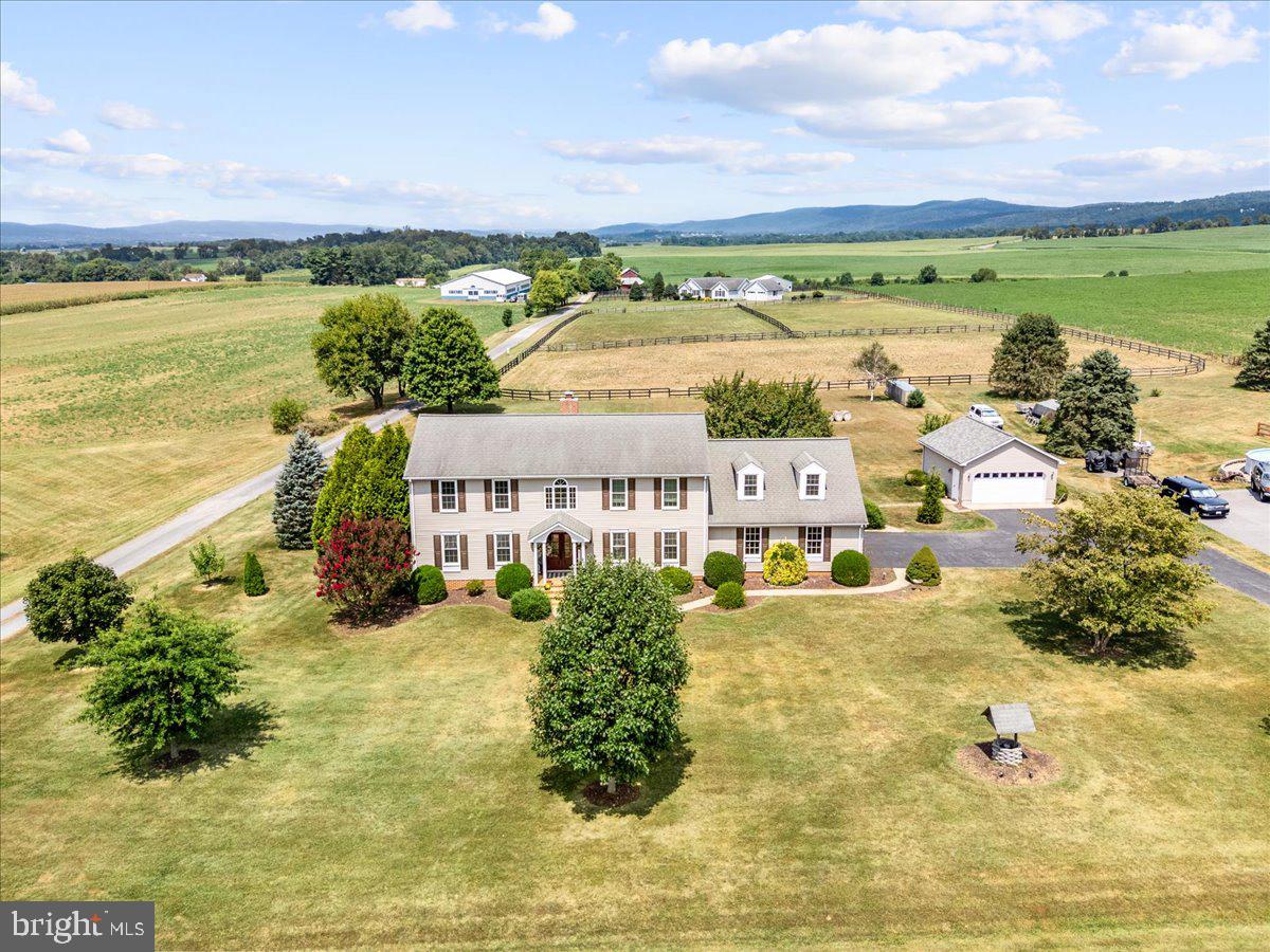 Set on 1.3 picturesque acres in the heart of the Middletown’s countryside, 3938 Cherry Lane presents a rare opportunity to experience refined living surrounded by breathtaking natural beauty. Surrounded by sprawling farmland with sweeping panoramic views of the mountains and Middletown Valley, this exceptional colonial offers an unmatched sense of privacy, tranquility, and timelessness. From vibrant sunsets to community fireworks, the scenery becomes part of everyday life — best enjoyed from the spacious rear deck overlooking the peaceful landscape.

Boasting over 3725 finished square feet, the property offers a seamless blend of classic design and comfortable living. The main level offers a dramatic two-story foyer welcoming you into the home, where the soaring family room is anchored by a wood-burning fireplace insert, framed by two full-glass French doors that perfectly capture the surrounding mountain and farmland views. Formal living and dining rooms create ideal spaces for entertaining, while the spacious kitchen features granite countertops, a seven-foot center island with seating, stainless steel appliances, cooktop, and double wall ovens — designed to accommodate both everyday living and memorable gatherings. A conveniently located half bath adds functionality for guests, while the mudroom and laundry combination offers practical everyday organization with ample space for storage, laundry, and easy access for busy households.

The upstairs features three extra-large bedrooms, including a primary suite complete with a walk-in closet and en suite bath. An additional finished bonus room above the attached two-car garage offers exceptional versatility, ideal for a home office, guest retreat, fitness studio, or creative space. In addition to the oversized attached two-car garage, the property also includes a detached two-car garage, offering ample space for vehicles, hobbies, or additional storage.

The fully finished lower level further enhances the home’s impressive living space, featuring a large recreation area, den, wet bar, full bath, storage area, and walk-up access to the backyard.

While the interior is exceptional, the outside is where the real show begins. The beautifully landscaped yard surrounds an inviting in-ground saltwater pool and relaxing hot tub, creating a private outdoor oasis perfectly suited for both quiet evenings and unforgettable entertaining. Beyond the property, neighboring horses grazing peacefully in the surrounding pastures add to the idyllic country setting, while the sweeping countryside views provide a stunning backdrop in every season.

Peaceful, private, and impeccably maintained, 3938 Cherry Lane offers the rare combination of scenic beauty, expansive living spaces, and exceptional outdoor living— all within the highly sought-after Middletown school district.

***Full photos will be available on 6/13.  Showings to begin 6/18, not before.
