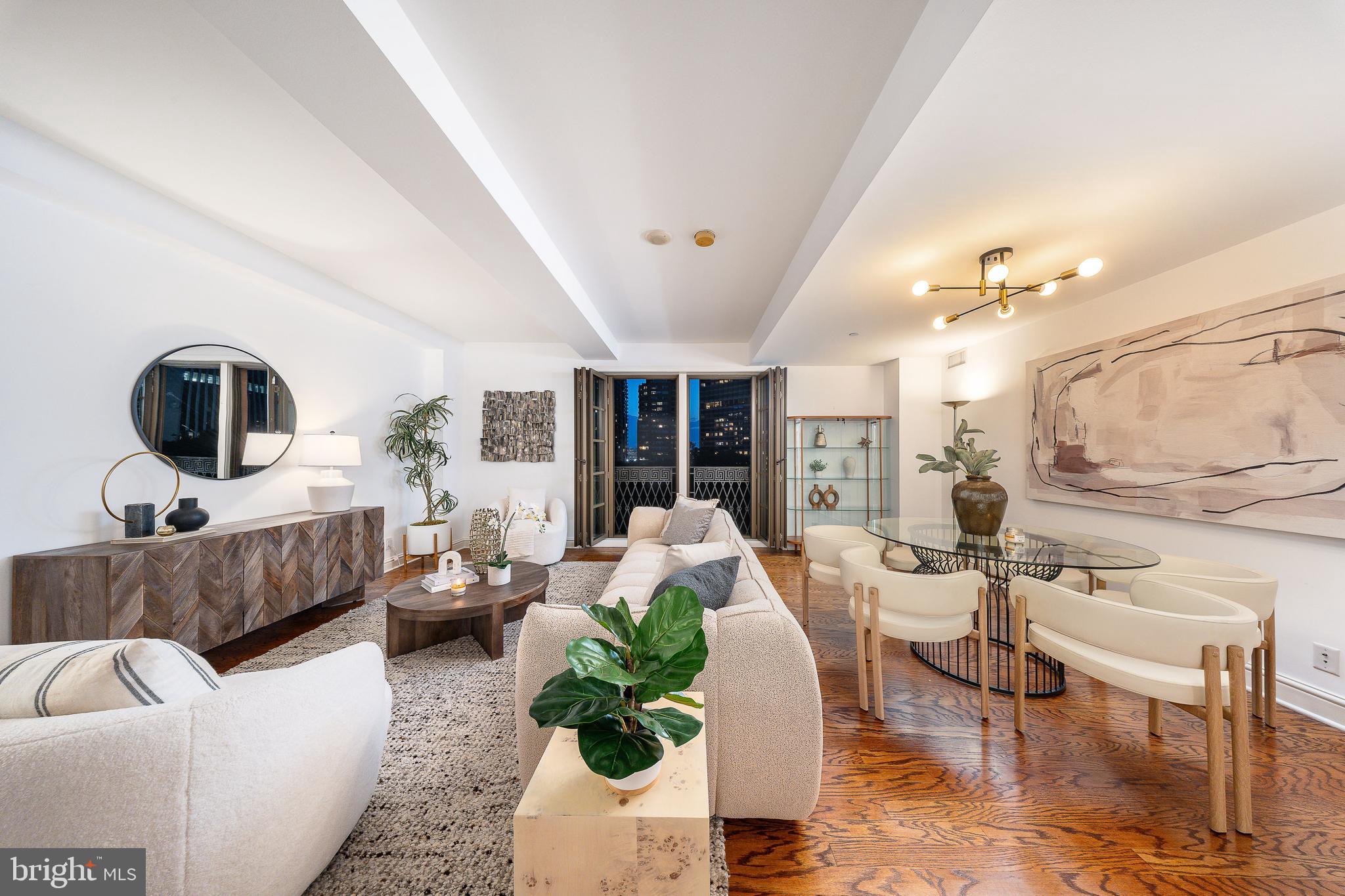 Where can you find a three-bedroom, three-bathroom residence overlooking the Square with parking? At Parc Rittenhouse #908, opportunity meets elegance in one of Philadelphia’s most iconic addresses. This rare, move-in-ready home is perched directly above Rittenhouse Square, with sweeping treetop and sunset views from every room that will make your heart skip, whether it’s your first glance or your hundredth.

From the moment you enter, you're welcomed by a refined open layout ideal for modern city living. The gourmet kitchen, lined with sleek flat-panel cabinetry, granite countertops, and stainless steel appliances, is open to the dining and living room, creating a seamless space for everyday living and effortless entertaining. From the kitchen, your eyes are drawn across warm hardwood floors to floor-to-ceiling French doors that lead to a Juliet balcony, framing iconic views of Rittenhouse Square’s lush canopy and the classic architecture that surrounds it. Whether you’re preparing a meal or sipping wine with friends, the ever-changing landscape of the Square becomes the backdrop to your daily life.

The thoughtful split-bedroom floor plan offers privacy and function, with a tranquil primary suite tucked away on one end, featuring a large walk-in closet and an en-suite bath with dual vanities and an oversized walk-in shower. On the opposite side, two generously sized bedrooms (each with access to their own full bathroom) make this home as flexible as it is beautiful.

And the ultimate luxury? A parking license for one valet garage space is included, an amenity nearly impossible to come by on the Square.

Parc Rittenhouse offers far more than a prestigious address. The newly renovated 7th-floor amenity level feels like an extension of your home: unwind by the outdoor pool and hot tub, lounge in the club room by the fireplace, host a meeting in the boardroom, or recharge in the state-of-the-art fitness center. With 24-hour concierge, pet-friendly policies (with restrictions), and Philadelphia’s top dining, boutiques, and culture just outside your door, #908 isn’t just a home, it’s a lifestyle.