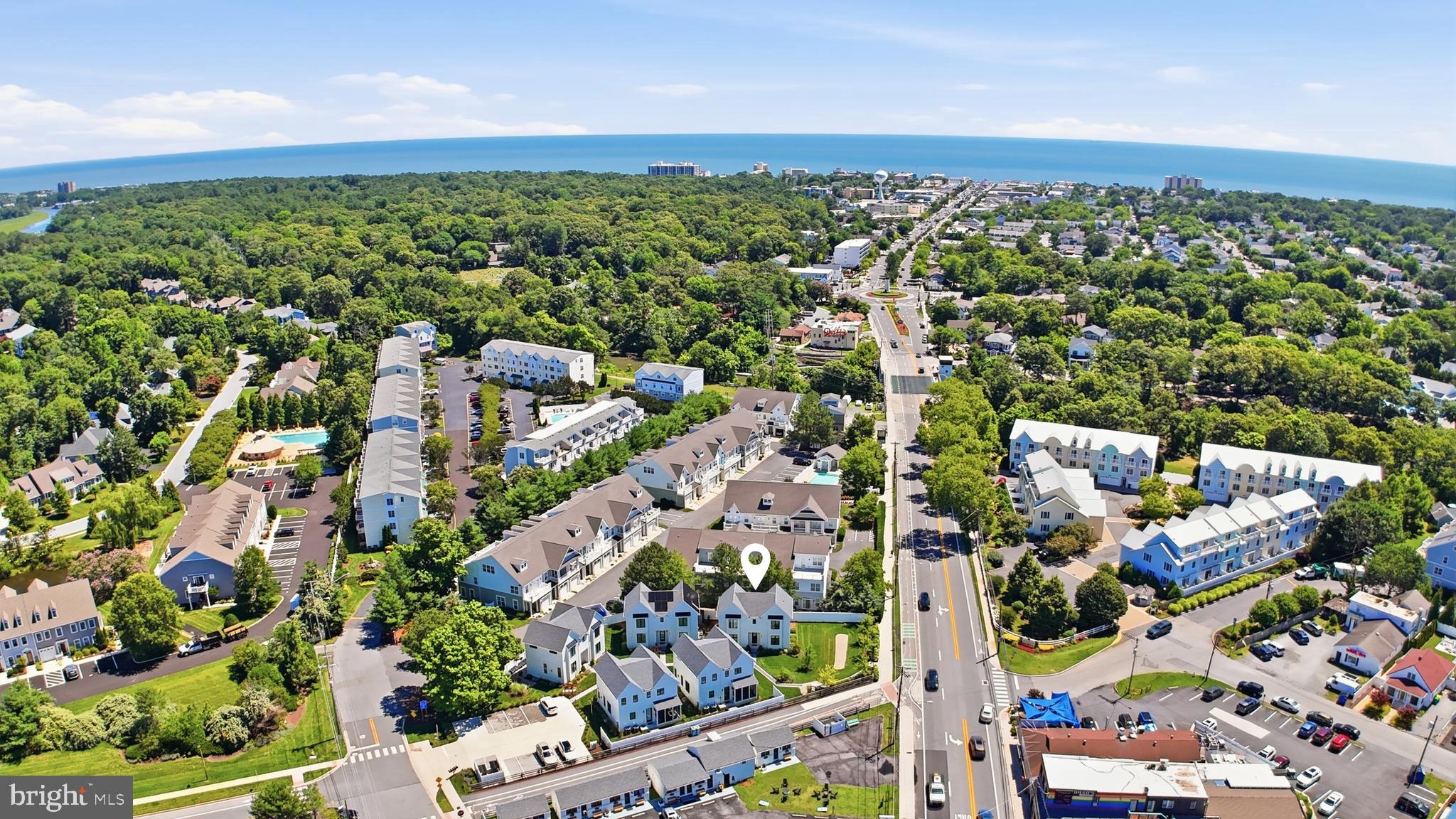 Perfectly positioned in an exclusive five-home enclave just moments from the iconic Rehoboth Beach Boardwalk, this exceptional three-level residence offers the ideal blend of modern coastal elegance, convenience, and investment potential. Meticulously maintained, this corner lot home features five bedrooms, four full bathrooms, assigned parking, and thoughtfully designed living spaces that cater to both everyday comfort and effortless entertaining.

The main level showcases an open-concept design filled with natural light, highlighted by luxury vinyl plank flooring, recessed lighting, and a striking shiplap-accented gas fireplace. The gourmet kitchen serves as the heart of the home, featuring quartz countertops, a spacious island with seating, gas cooking, pantry storage, and seamless access to the backyard. A formal dining area and first-floor bedroom with a full bath provide flexibility for guests or multigenerational living.

Upstairs, the spacious primary suite offers a private retreat complete with dual walk-in closets and a beautifully appointed ensuite bath featuring a tiled shower and dual-sink vanity. Two additional bedrooms, a full hall bath, and convenient second-floor laundry complete the level. The fully finished basement expands the living space with an additional family room, fifth bedroom, and full bathroom—perfect for guests, recreation, or a private getaway.

The location is truly unmatched. Situated 1.2 miles from the Rehoboth Beach Boardwalk and Atlantic Ocean, residents enjoy easy access to award-winning restaurants, boutique shopping, entertainment, and year-round events. Nearby attractions include Tanger Outlets, Junction & Breakwater Trail, Grove Park, Rehoboth Bay, and countless opportunities for boating, biking, dining, and coastal recreation.

Whether you're seeking a sophisticated primary residence, a luxurious beach retreat, or an income-producing investment property, this turnkey home delivers the quintessential Rehoboth Beach lifestyle with the convenience of low-maintenance living and unparalleled access to Delaware's most sought-after coastal destination.