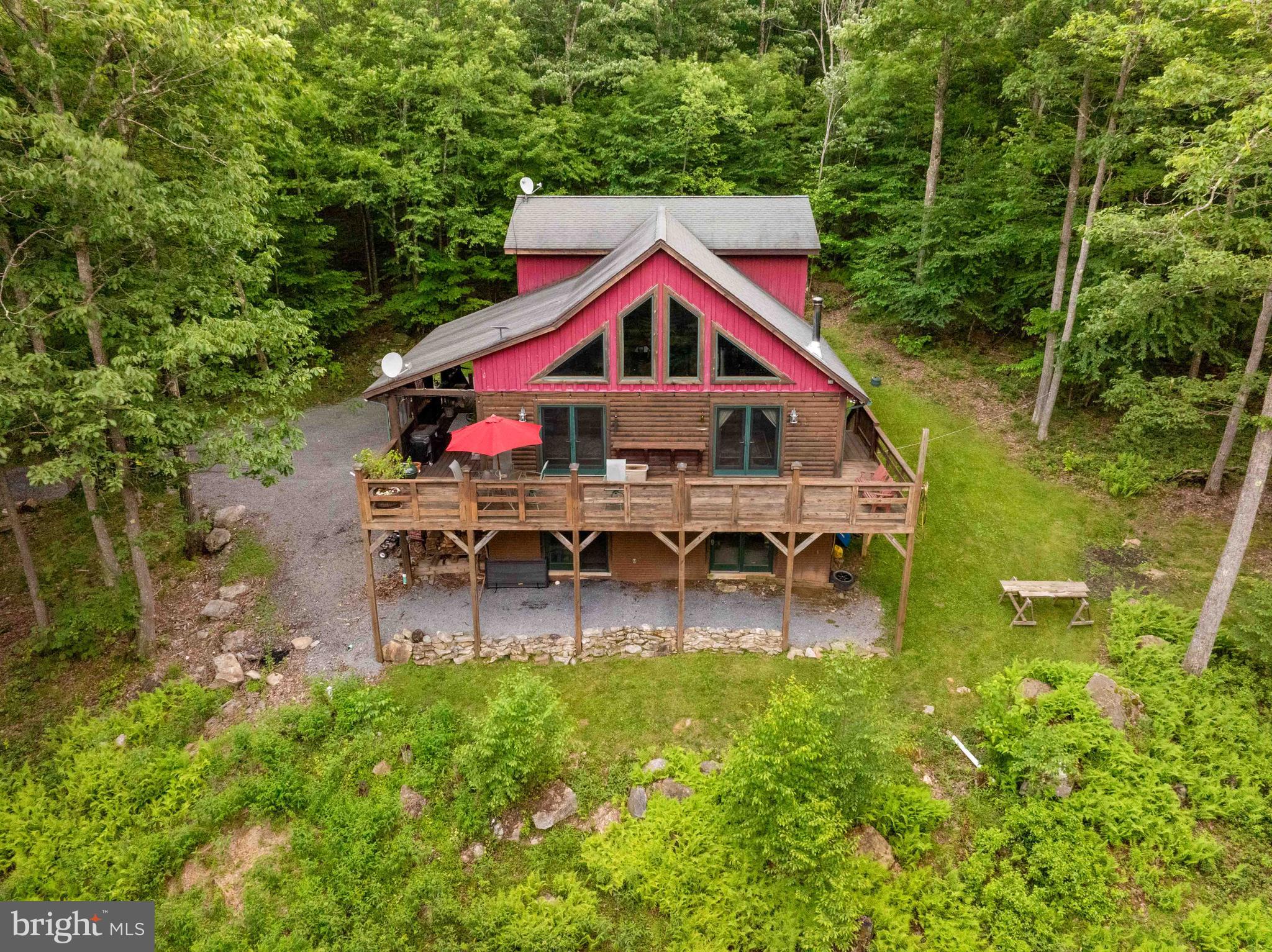 4BR 2.5BA cabin in the woods! Over 12 wooded acres of privacy and seclusion, laced with trails and surrounded by low maintenance land. Centrally located - only a few miles to Deep Creek Lake, town of Oakland or Swallow Falls State Park.  Open floor plan with vaulted ceilings, a wood burning stove and high end finishes throughout. Basement is partially finished. Spacious decking and a must-have covered porch to enjoy the outdoors. Perfect as a vacation retreat or a full time residence. Located at the end of a privately maintained road. No vacation rentals permitted.