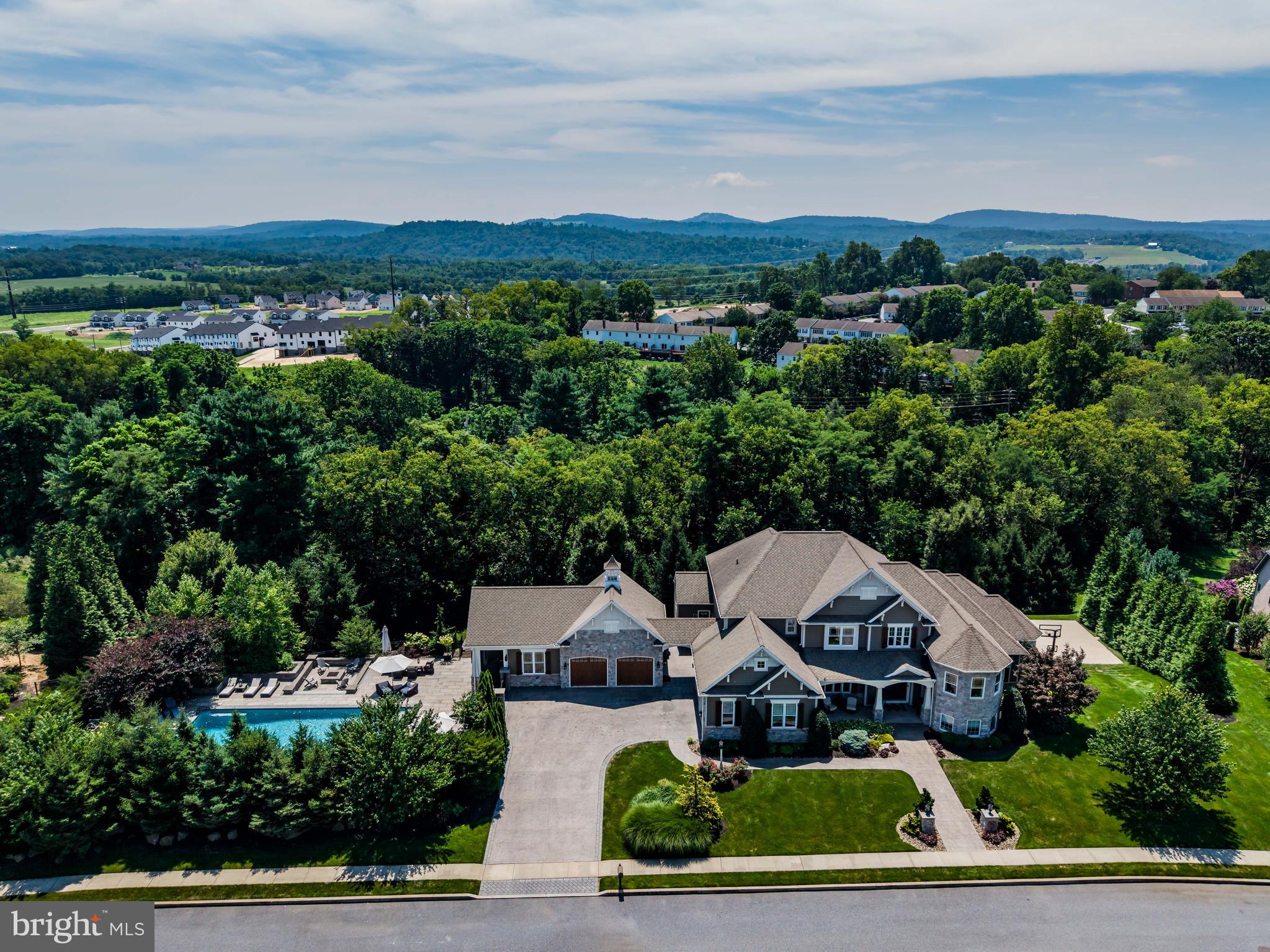 **Price reduction good until 12/26/2025.** 
This exceptional 5 bed, 4 full & 3 half bath home blends luxury and lifestyle on nearly 1 acre—set on a rare double lot in the sought-after Mechanicsburg School District. Inside, discover soaring ceilings, intricate coffered details, elegant stonework throughout, and stained glass in the primary suite shower. Each bedroom offers its own walk-in closet, custom-designed by California Closets. Thoughtfully designed for both comfort and entertainment, the home includes a full-sized home gym, a private in-home theater, and a basketball court perfect for friendly games. Step outside to your personal retreat: a 1,500 sq ft resort-style pool with waterslide, a screened-in cabana, and a cozy fire pit for evening relaxation. With a perfect blend of luxury finishes and resort-style amenities, this home is an entertainer’s dream and a true sanctuary—all while being conveniently located near parks, schools, and more.