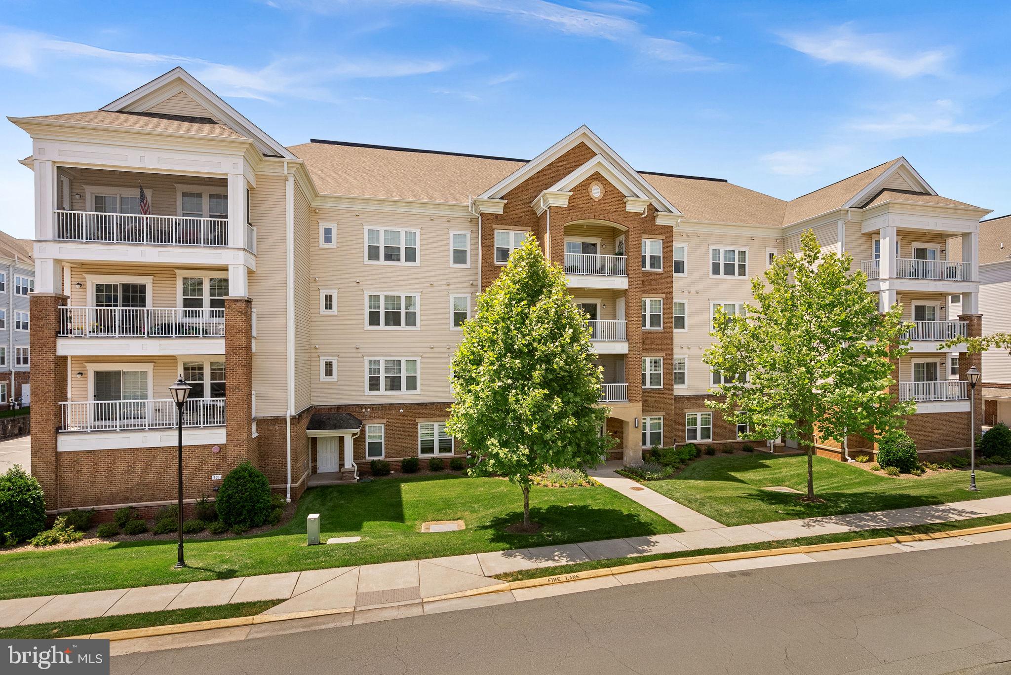 Experience the ease of low-maintenance living in this beautifully maintained third-floor condominium located in the highly sought-after Potomac Green, an established age-restricted active adult community in Ashburn. This inviting home offers two spacious bedrooms, two full bathrooms, and a versatile den, perfect for a home office, library, hobby room, or additional guest space. The open-concept floor plan features a bright living area, dedicated dining space, and a well-appointed gourmet kitchen designed for both everyday living and effortless entertaining. Enjoy the convenience of secure building access, gated community entry after hours, an oversized elevator, and a reserved covered parking space ideally located next to the building’s side entrance. Potomac Green offers an exceptional resort-style lifestyle with a beautifully appointed clubhouse, ballroom, indoor and outdoor pools, fitness center, indoor walking track, library, lounge, billiards and card rooms, meeting spaces, picnic areas, and a vibrant calendar of social events and wellness activities. Ideally situated just minutes from One Loudoun, shopping, dining, entertainment, and Dulles International Airport, this move-in-ready home offers the perfect blend of comfort, convenience, and community.