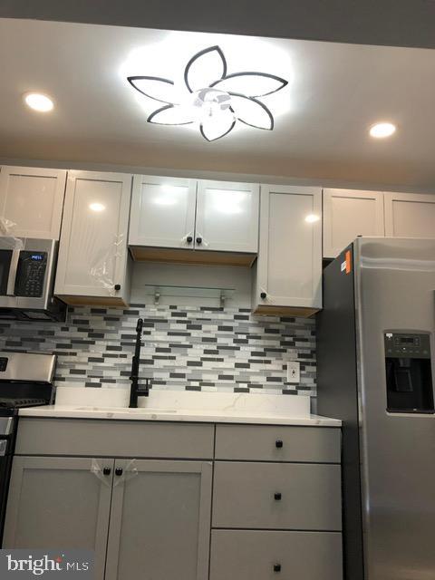 ***Seller will pay $2,000 towards buyer's closing costs.***  Discover the charm of this beautifully maintained townhouse nestled in the desirable Walbrook neighborhood. With stunning brand new vinyl flooring throughout, this inviting 2-bedroom, 1.5-bathroom home, built in 1951, seamlessly blends classic character with modern convenience, making it the perfect retreat for those seeking comfort and style. Step inside to find a thoughtfully designed interior that maximizes space and functionality. The cozy dining area is perfect for intimate meals or entertaining friends, while the partially finished basement offers endless possibilities-transform it into a home office, a playroom, or a cozy den. With an outside entrance, this space provides easy access, enhancing the overall ambiance of the home. The kitchen is equipped with brand new stainless steel appliances including a built-in microwave, gas oven/range, and refrigerator with water/ice dispenser.  Whether you're whipping up a gourmet meal or enjoying a quick breakfast, this kitchen is designed to meet all your cooking needs. The convenience of a washer and dryer ensures that laundry day is a breeze, allowing you to spend more time enjoying your new home. The two spacious bedrooms provide a serene escape, each offering ample natural light. The well-appointed bathrooms, including a full bath and a convenient half bath, cater to your daily routines with ease. The low-maintenance lot size of just 0.02 acres allows you to enjoy your outdoor space without the burden of extensive upkeep. With its prime location in Walbrook, you'll find that this home affords easy access to local amenities, parks, and community resources, making it an ideal choice for those who value convenience and community.  **Home warranty included.**  Don't miss the opportunity to make this charming townhouse your own. Schedule your private tour today and envision the possibilities that await you in this delightful home!