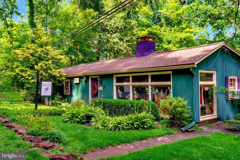 Unlock a world of creative possibilities with this unique dual-purpose property, along with a separate 2-bedroom cottage. Currently serving as an antique shop, the main level greets you with expansive rooms with plenty of light from the large windows, anchored by a  free-standing stone fireplace. With eight dedicated parking spots along the road, your clients or guests will find visiting effortless.  There is also ample parking behind.

The transition from work to home is seamless. Tucked away for maximum privacy is a spacious residence featuring a dedicated side entrance and internal access. The open-concept living, dining, and kitchen area creates a warm, inviting atmosphere for relaxation. Large scale windows and a sliding glass door open to a wrap around deck that overlooks the canal and a charming camelback bridge. Two comfortable bedrooms offer generous double closets, providing the perfect footprint for a quiet retreat or a professional home office.

The potential only grows as you explore the lower levels. A versatile bonus room comes equipped with laundry and an adjacent walk-in storage closet, while the massive basement serves as a dream canvas for makers and hobbyists. Complete with a workshop area, garage access, and a half-bath ready for your finishing touches, there is no shortage of space to expand your vision.

Outside, a charming guest cottage offers even more flexibility for living, renting, guests or specialized projects. Whether you’re looking to launch a boutique, host an artist's studio, or simply enjoy a lifestyle where your passions and your home are one, this property is ready for its next chapter. Bring your dreams and see how this versatile space can work for you.
