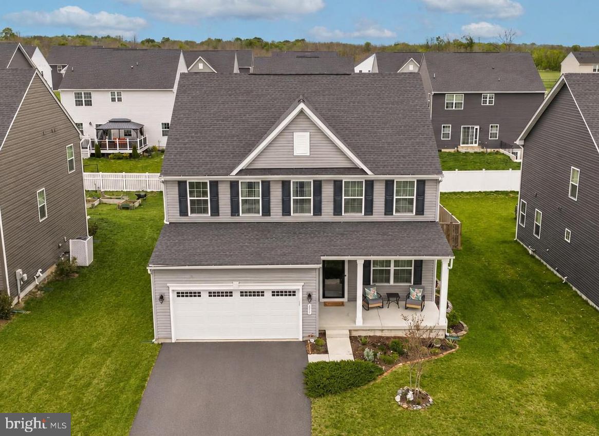 Welcome to 217 Machias Circle! Built in 2022, this home still has that fresh, new construction feel without the wait. Set in a well-established neighborhood, this home offers more than just great living space—you will love the nearby dog park, playground, and pavilion.
Upon entering, you are welcomed by a private office space with elegant French doors—ideal for remote work or a cozy flex space. Continue down the hall into the heart of the home, where an open-concept kitchen, living, and dining area creates an ideal space for everyone. LVP flooring flows throughout, recesses lighting complements the white kitchen cabinetry, granite countertops, stainless-steel appliances and a gas range with hood. Decorative pendant lighting and a stylish chandelier bring a touch of charm to the space. Also on this level, you will find access to the two-car garage and a convenient “family entrance” area, complete with a powder room, spacious pantry, and coat closet.
Head upstairs to the generously sized primary suite, complete with a large walk-in closet and elegant tray ceilings that add depth and character. The en-suite bath offers a dual vanity and a tiled shower with dual shower heads, a built-in bench, and a sleek glass door. Completing the upper level are three additional well-sized bedrooms, a hall bath featuring a tiled tub/shower combination, and a conveniently located laundry room. 
Adding to this already spacious home, the finished basement offers incredible flexibility—perfect for a recreation room, home gym, media space, or guest suite. It features recessed lighting, a full bath with a tiled walk-in shower and glass door, and a large unfinished storage area that also houses the utilities. A water softener and filtration system were added in 2024.
Outside, enjoy a thoughtfully designed space featuring a children’s play area and a beautifully landscaped garden that offers both fun and tranquility. The yard showcases native perennials, designed to attract butterflies and seasonal color. Surrounding the property, you’ll find a variety of plantings including bleeding hearts, hostas, lavender, catmint, hydrangeas, and lamb’s ear. Call today for more information!