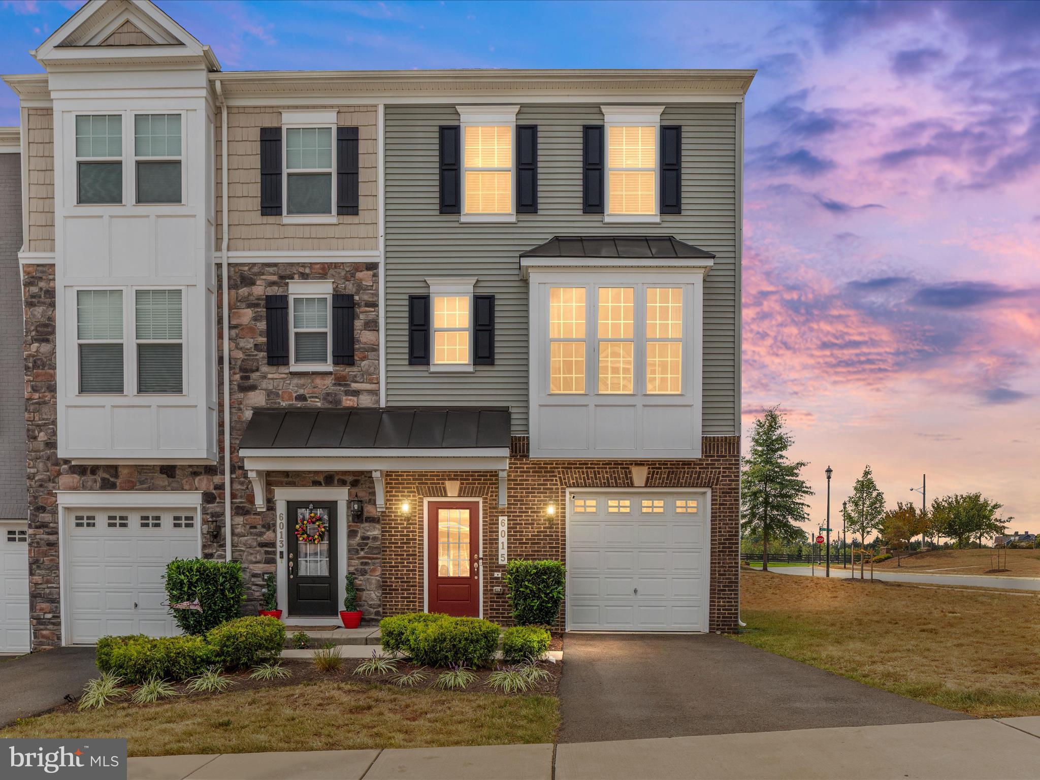 Welcome to this stunning 3 bedroom, 3.5 bathroom end-unit condo townhome with a 1-car garage and over 2,100 finished square feet of stylish living space. Built in 2020 and meticulously maintained, this home showcases modern finishes, abundant natural light, and all of the builder’s top upgrades—making it truly move-in ready.
The main level features a freshly painted open floor plan with a gourmet kitchen, pantry, spacious dining area, and a bright living room that flows seamlessly to a private deck overlooking the community common area—no neighbors directly behind you! A convenient half bath completes this level.
Upstairs, the primary suite boasts a walk-in closet and a spa-like en suite bathroom. Two additional bedrooms, a full hall bath, and a laundry room add everyday ease.
The walk-out basement provides a versatile living area, a full bathroom, and direct access to the back patio, where you’ll find a community pavilion and picnic area—perfect for relaxing or entertaining.
This home offers low-maintenance living with exterior care and lawn maintenance included. Luxury vinyl plank flooring runs throughout the entire home, with carpet only in the bedrooms for comfort. As an end unit, enjoy extra windows, additional privacy, and plenty of sunlight. Located just minutes from major commuter routes, top-rated schools, shopping, and the charming restaurants of Old Town Haymarket, this home combines comfort, style, and convenience. Never before listed, this home is truly one of a kind.