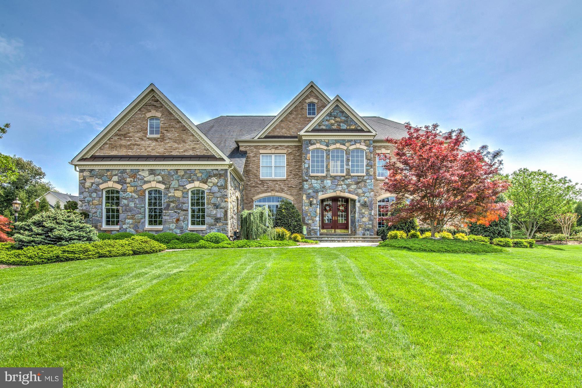 Upgrades abound in the light filled 5BR 5BA SF. Enjoy spacious elegance wth almost 8500SF.  Large gourmet kitchen with island, SS appl, double sinks, tile floor & granite counters. Brazilian Cherry hardwood floors, two story foyer, and family rm along with 2 sunrooms on main level. MBR w/sitting area, dbl walk-in closets custom cabinets, master bath with double oversized shower and so much more!