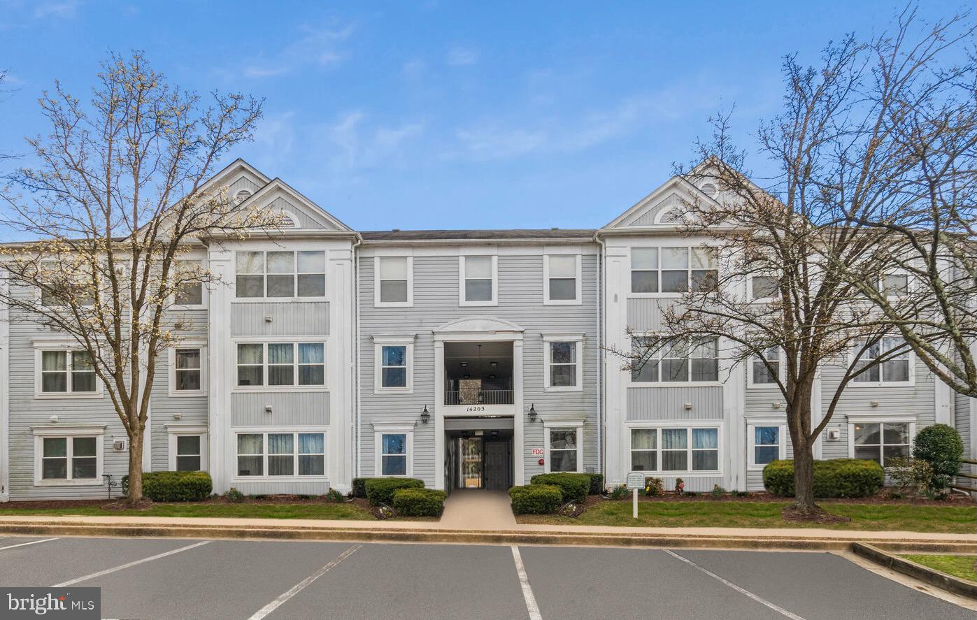 Welcome to 14203 Wolf Creek Place #2-23, a wonderful two-bedroom, two-bathroom condo located in the Wintergate at Longmead Crossing in Silver Spring, Maryland. Boasting over 800 square feet of living space, this fantastic condo is the perfect place to call home. As you step through the front door, you are welcomed into an inviting open floor plan. The living area is complete with a ceiling fan, an electric fireplace, and oversized windows that fill the room with natural light. On the opposite side of the room, you'll find the dining area, perfect for entertaining or enjoying a quiet meal at home. The kitchen is fully equipped and offers ample cabinet space for all of your storage needs. A side-by-side washer & dryer are conveniently tucked behind double doors in the hallway, making laundry day a breeze. The primary bedroom is a peaceful oasis, complete with a walk-in closet and en-suite bathroom featuring a modern vanity. The secondary bedroom is perfect for use as an office or guest room. The condo's ground-level location offers easy access to plentiful resident parking and all the amenities of the community, including a community pool and playground.  With its prime location just minutes away from I-495 and multiple shopping centers, you will have everything you need at your fingertips. This condo is the perfect blend of comfort and convenience -with an open floor plan, modern amenities, and a prime location. Don't miss your chance to make it your own!