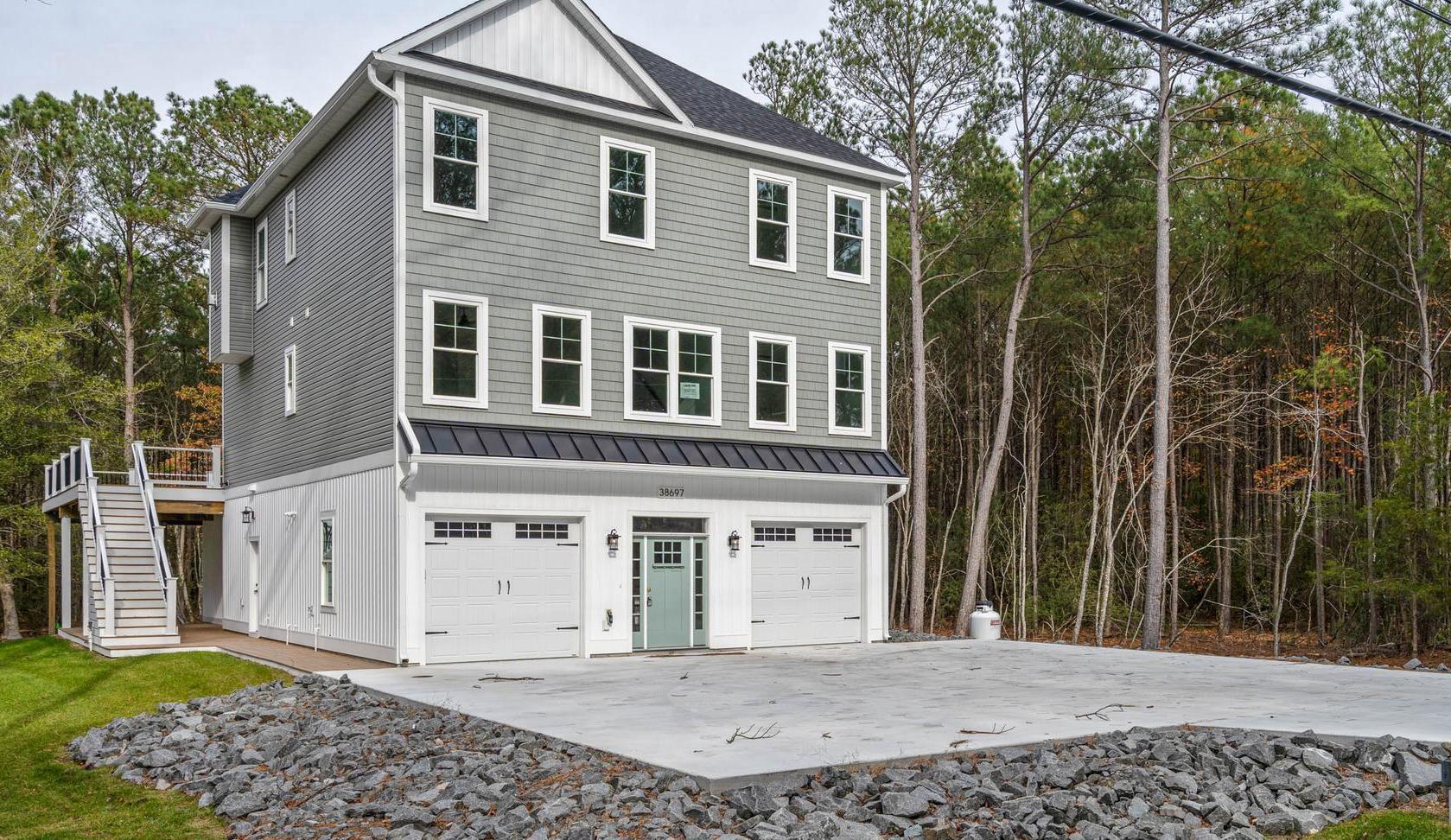 Move in Ready! This beautiful coastal home is situated on an oversized wooded lot, located just minutes from downtown Bethany Beach and a short distance to the sand.  Access the spacious upper level by elevator. Here you will find a beautifully designed kitchen, featuring stainless appliances, gas fireplace, large screen porch, primary suite and guest bedroom and bathroom with custom tile and upgraded counter tops. Sit and enjoy the outdoors and the beautiful scenery this lot has to offer on the expansive deck located on the second floor.  Just inside you will find a wet bar complete with a refrigerator and microwave for entertaining guests, 3 additional bedrooms and 2.5 baths and a large laundry room with washer and dryer round out this floor. On the lower level you have a large game room / flex room with a full bath. This allows you ample space for additional sleeping if needed. Pilings for a future pool have already been put into place under the expansive deck. Tax information is based on undeveloped land and does not reflect true annual tax fees. Even though they are not pictured all walk-in showers have glass doors.